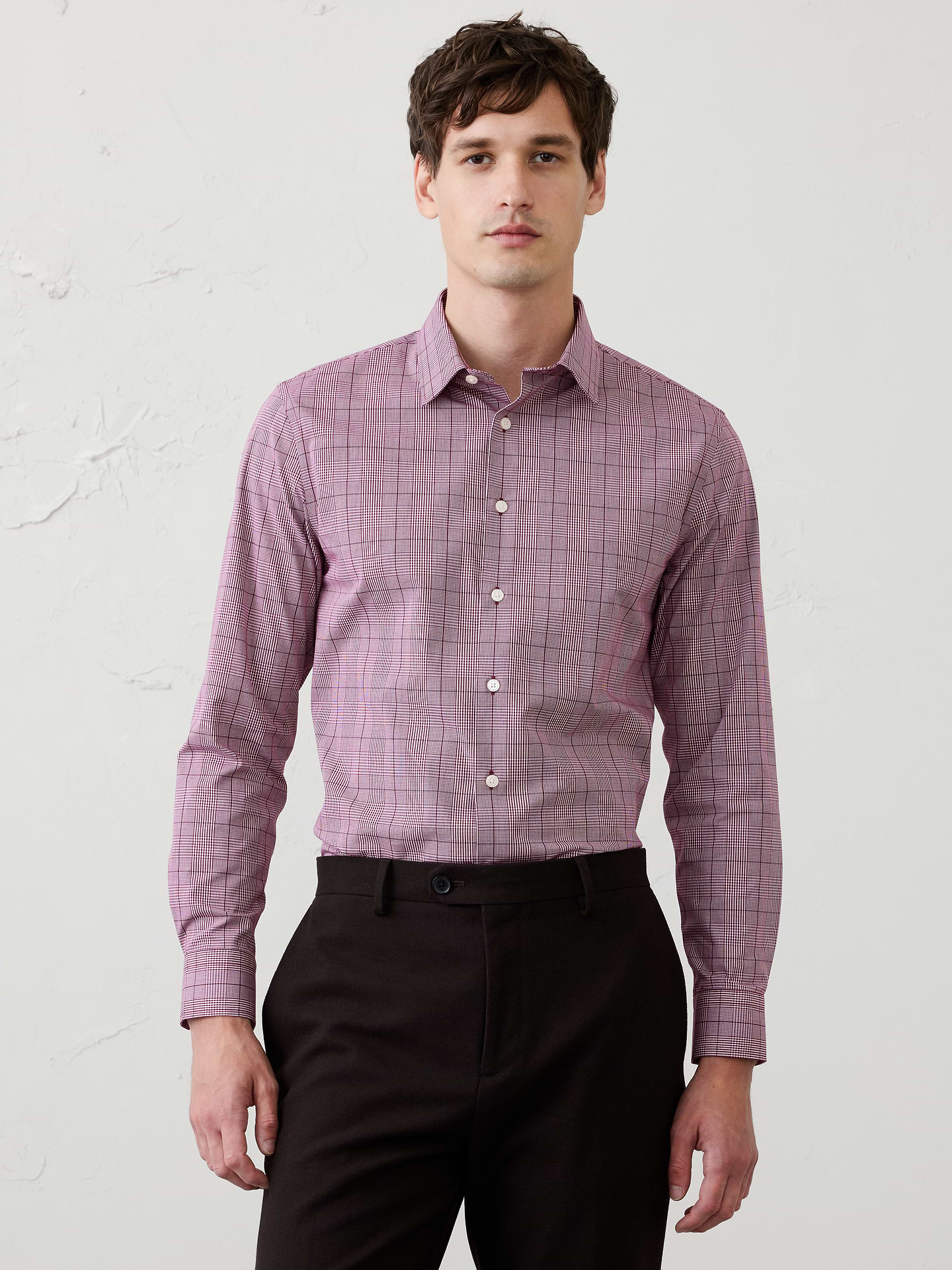 Image 1 of 8, WRINKLE RESISTANT: No need to iron, these soft, cotton dress shirts are specially engineered to resist wrinkles so it stays looking crisp and pulled-together., UNTUCKED: Designed with a shorter hemline to hit right at the hips., Spread collar. Long sleeves with adjustable double-button barrel cuffs and button vents., Clean front., Shirttail hem., Made exclusively for Banana Republic Factory., Product #1175947