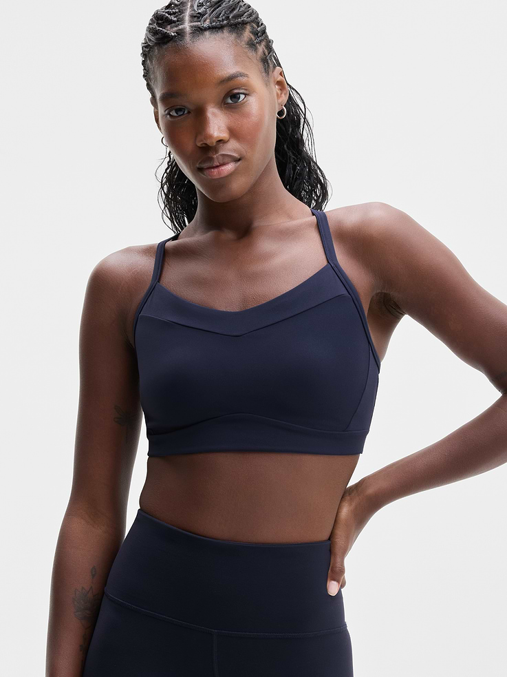 Image 1 of 5, BEST FOR STUDIO: yoga + barre + pilates, IMPACT: Light-impact workouts, best for D-DD cups, FEEL: Powervita fabric is buttery soft with support that feels like a gentle hug, FAVE: Sleek racerback design provides distraction-free mobility and airflow, Built-in pockets with removable pads for optional coverage, Lined with PowerMesh for breathable, sheer-proof coverage, Product #769482