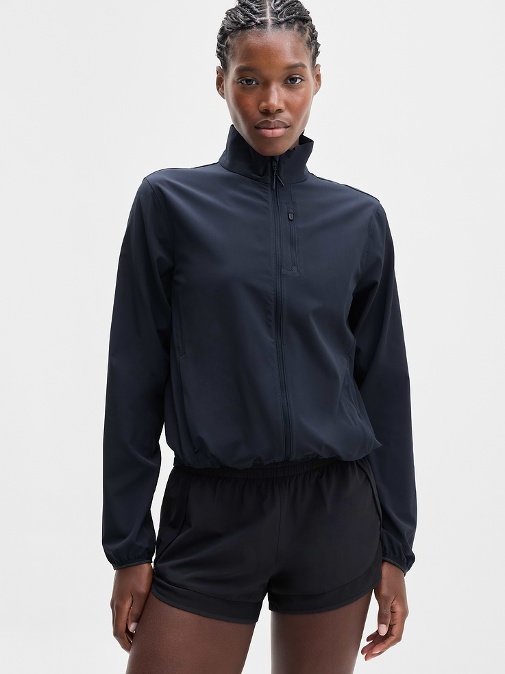 Image 1 of 7, FOR: Hitting your pace in nearly any place, from sidewalks to trailheads, FEEL: Recycled Featherweight Stretch fabric feels silky-sleek and light as air, FAVE: Bungee cord on hem makes customizing your fit a cinch, Secure zip pockets store your essentials, Ventilated back helps keep you cool, Thumbholes hold sleeves in place, Product #578072