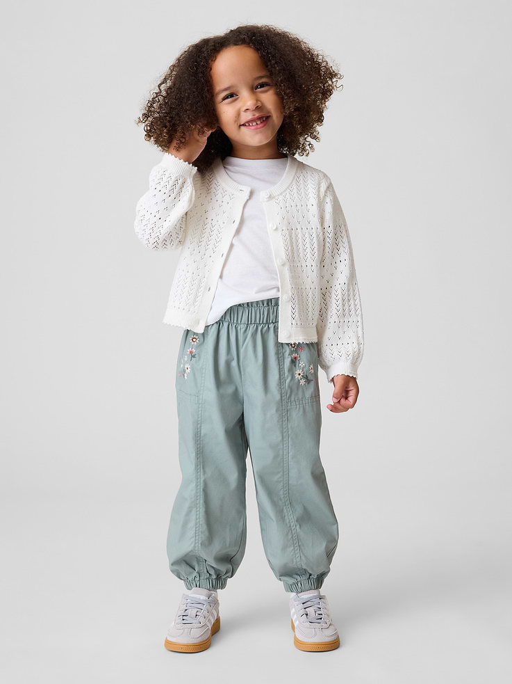 Image 1 of 4, Smooth cotton poplin pull-on joggers., Elasticized ruffle waist., Embroidered floral detail and seaming detail at front., Elasticized cuffs., Made with 100% regeneratively grown cotton which is grown using holistic agricultural practices that aim to improve soil health and water retention., Product #912386