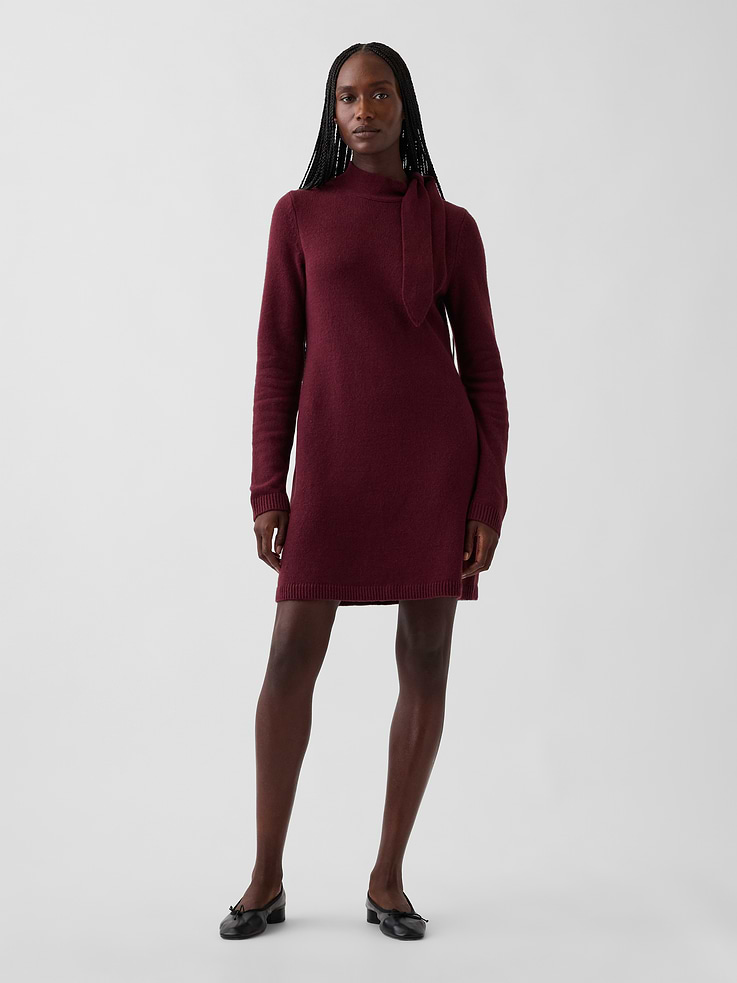 Image 1 of 6, Supersoft knit cotton-blend mini sweater dress., Tie neck., Long sleeves., Ribbed hem., This product was made in a factory that invests in gender equity and women’s empowerment through RISE. Learn more at gapinc.com/equity ., Product #1184694