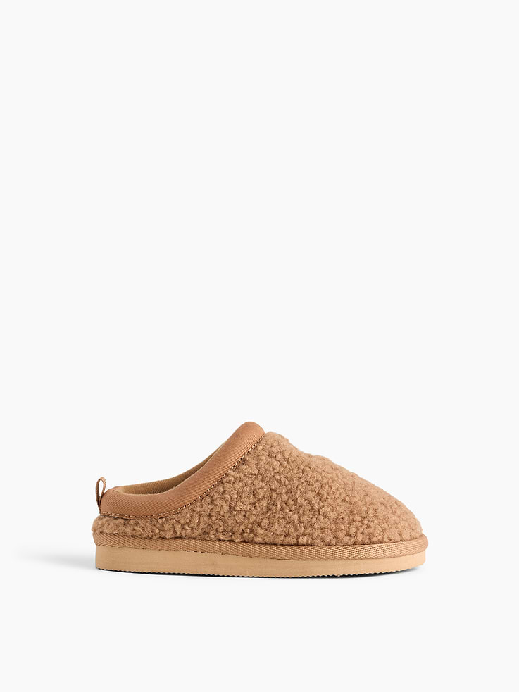 Image 1 of 4, These clog slippers are made with a soft sherpa upper., Rubber gripper sole., Embroidered Brannan Bear at top., Product #1185867