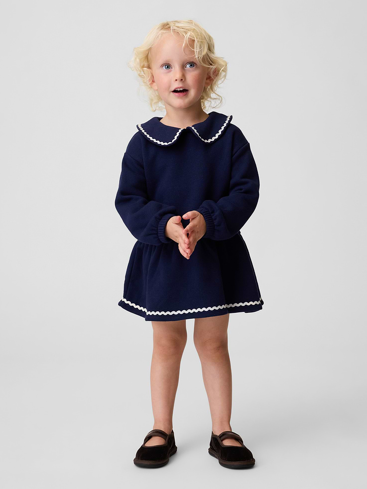 Image 1 of 3, Soft cotton-blend fleece sweatshirt dress., Peter Pan collar with ric rac trim and loop button keyhole closure., Long sleeves with elasticized cuffs., Shirring at drop waist., Made with 21% recycled polyester. Compared to virgin materials, using recycled materials helps reduce resource use and waste., Product #912137