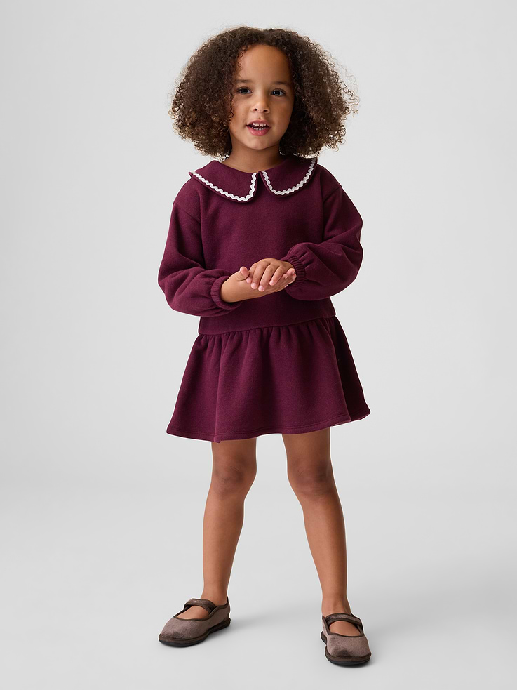 Image 1 of 3, Soft cotton-blend fleece sweatshirt dress., Peter Pan collar with ric rac trim and loop button keyhole closure., Long sleeves with elasticized cuffs., Shirring at drop waist., Made with 21% recycled polyester. Compared to virgin materials, using recycled materials helps reduce resource use and waste., Product #912137
