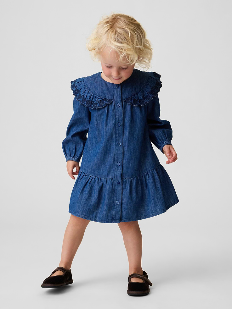 Image 1 of 2, Soft cotton denim button-up dress., Round collar, button front., Ruffled detail at yoke with embroidered eyelet detail and scalloped edge., Long sleeves with elasticized cuffs., Shirring at drop waist., Responsibly Made: This denim dress is part of our water-saving Washwell program. Compared with conventional wash methods, Washwell uses at least 20% less water., Product #912215