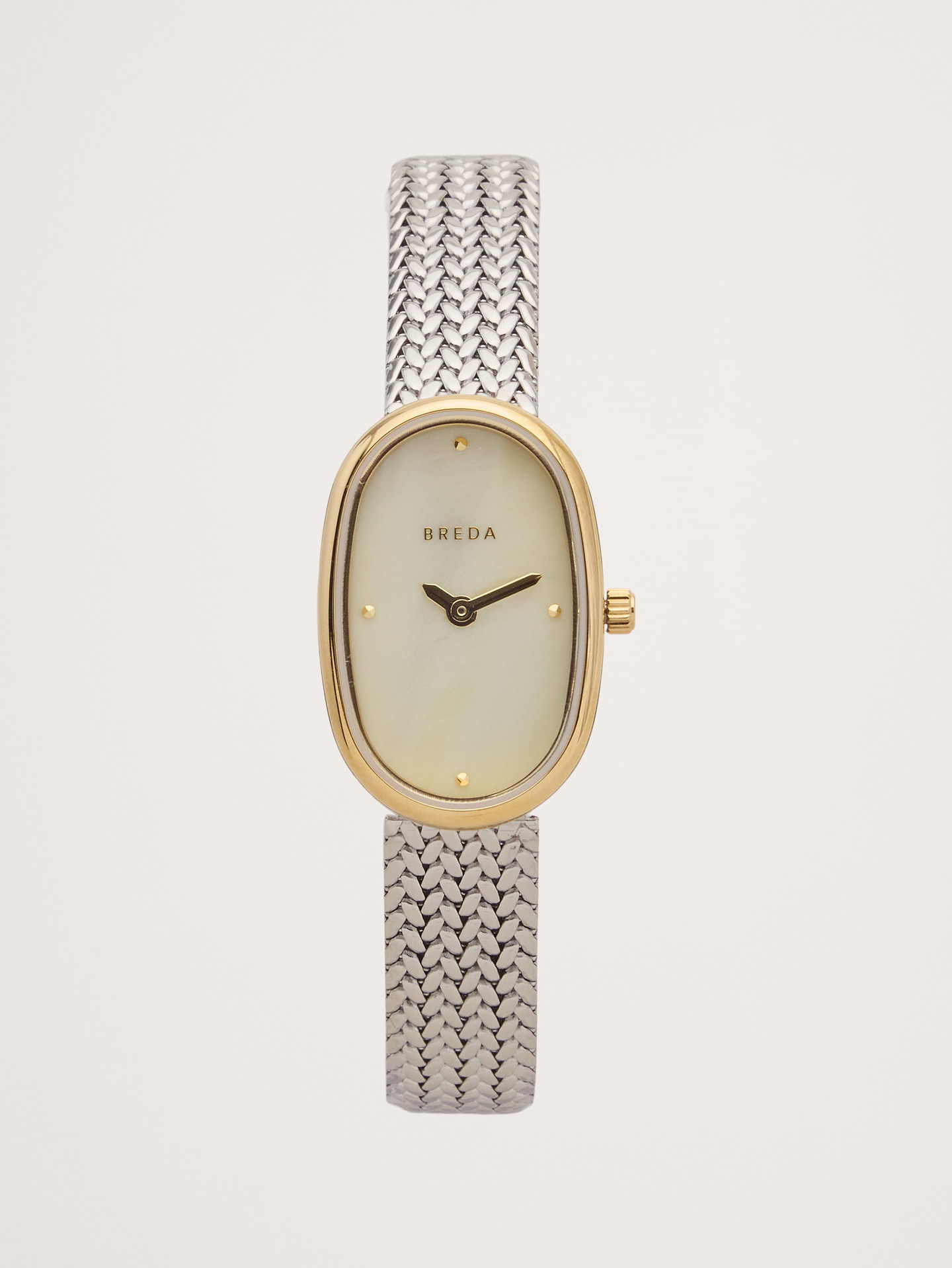 Image 1 of 2, The Tethered collection exists as a daily reminder of our human connection and our shared memories intertwined, endlessly collapsing together. The Jane (Tethered) carries a delicate 18mm oval case, champagne mother of pearl dial and a tapered woven mesh bracelet that fastens with a quick release clasp., Breda: Dallas-based watch brand crafting reimagined classics with an inclusive spirit—designed for self-expression and timeless style., 18K-gold plated case. Gold-plated woven metal strap., Made in Japan., *Mother of Pearl is a product of nature, there will be variances in texture on each dial., *Mother of Pearl is a product of nature, there will be variances in texture on each dial., Product #1193249