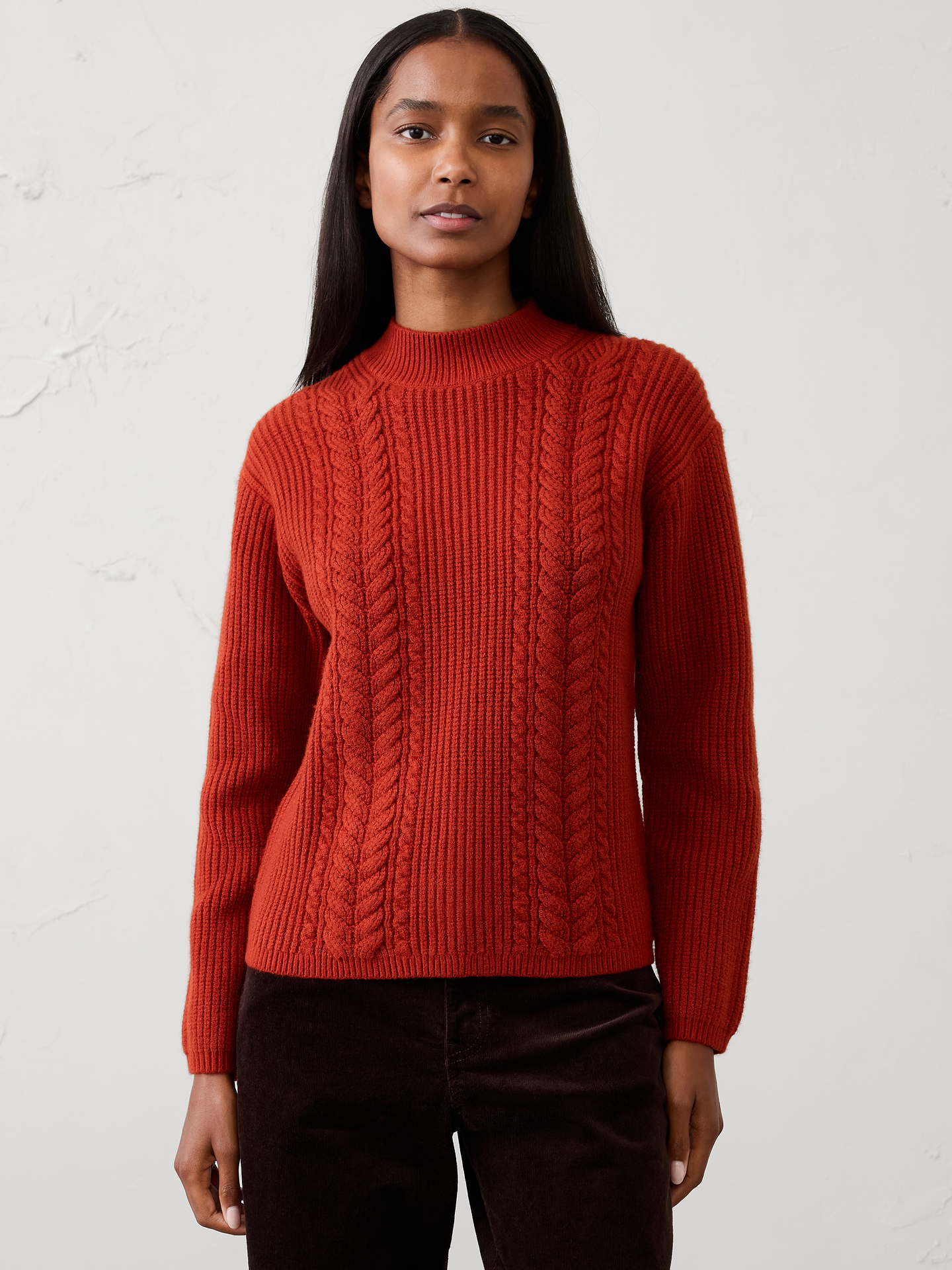 Image 1 of 4, Our sweater is knit from our signature Perfectly Soft yarn—a luxurious blend of cotton with a hint of wool, that feels as cozy as it looks. Classic cable stitching adds timeless texture and dimension, elevating the silhouette with a heritage‑inspired touch., Mock neck. Long sleeves., Drop shoulders., Made exclusively for Banana Republic Factory., Product #1177060