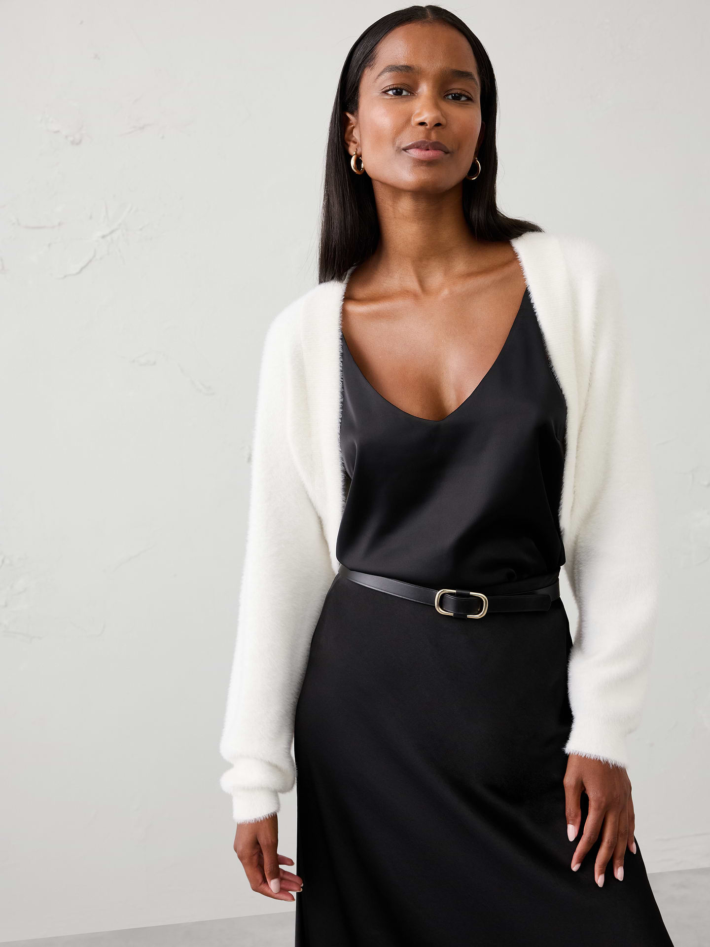 Image 1 of 4, Made from our plush eyelash yarn, this shrug offers a luxuriously soft hand feel with a light, fuzzy texture. The easy silhouette is perfect for layering over dresses and tops, adding warmth and softness without feeling bulky., Open‑front design. Long sleeves., Drop shoulders., Care suggestion: Use a low‑heat iron; steam as needed., Made exclusively for Banana Republic Factory., Product #1177092