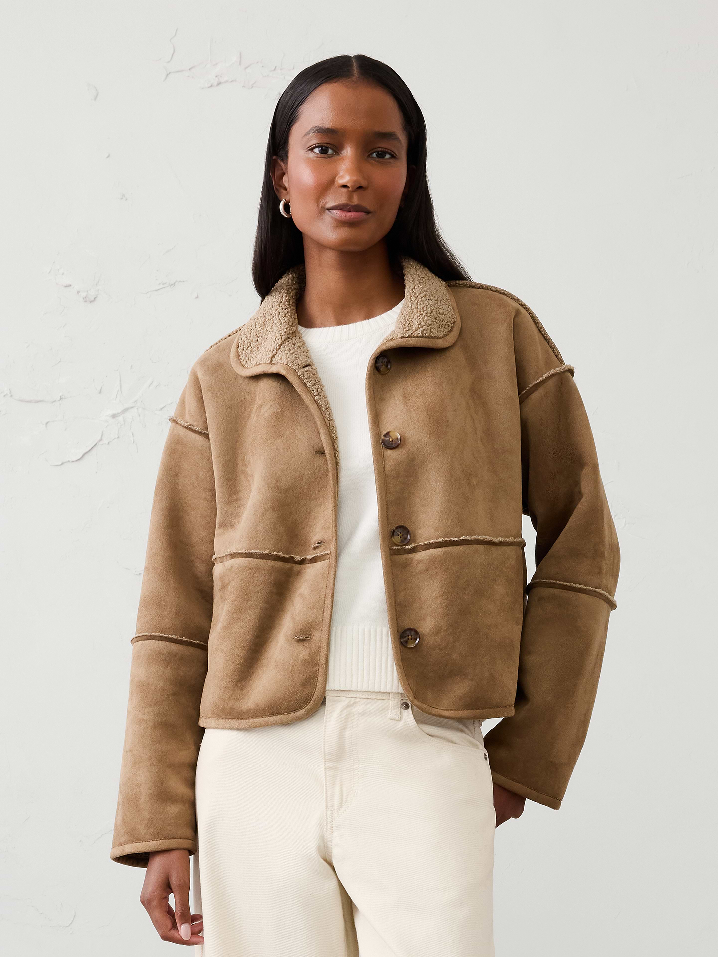 Image 1 of 4, Two looks in one. Designed to be fully reversible, this jacket lets you switch between luxe vegan suede and cozy sherpa for twice the styling possibilities. Soft, warm, and versatile, it offers effortless comfort and value while making it easy to adapt your look for any occasion or cold‑weather adventure., VEGAN SUEDE: Soft and smooth, this faux suede looks and feels luxurious., Mockneck collar. Long sleeves., Drop shoulders., Button-front closure., On-seam front pockets., Made exclusively for Banana Republic Factory., Product #1178072