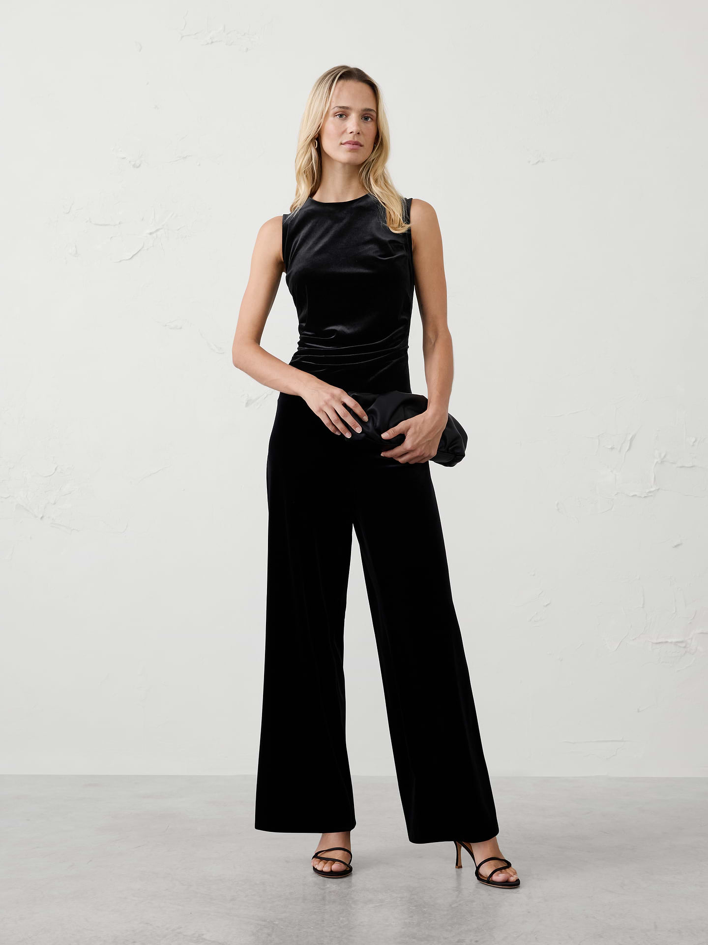 Image 1 of 4, Make every occasion feel special in this velvet draped jumpsuit, crafted from soft knit velvet. Whether styled for holiday parties, dinners, or evening celebrations, this one-and-done statement piece brings timeless glamour to any event., Crew neck. Sleeveless., Draped bodice., Tailored waist., Hidden back zipper closure., Made exclusively for Banana Republic Factory., Product #1185683