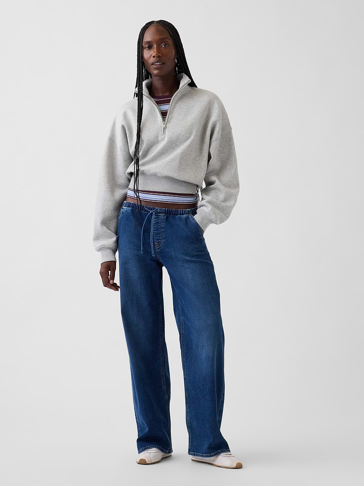 Image 1 of 6, Fit: A full-length knit denim loose jean that's fitted on the waist & relaxed all the way down., Fabric: 79% Cotton, 20% Recycled Materials, 1% Stretch., Stretch: Low Stretch Jeans. Authentic denim with a soft & easy lived-in feel.​, Rise: Low Rise Jeans., Look: An easy loose jean in a medium wash., Details: Elasticized waist with drawcords, front slant pockets, & back patch pockets., Responsibly Made: This pair of jeans is part of our water-saving Washwell program. Compared with conventional wash methods, Washwell uses at least 20% less water., More Sustainable Materials: Made with 15% polyester and 5% recycled cotton. Compared to virgin materials, using recycled materials helps to reduce resource use and waste., This product was made in a factory that invests in gender equity and women’s empowerment through RISE. Learn more at gapinc.com/equity ., Product #1185283
