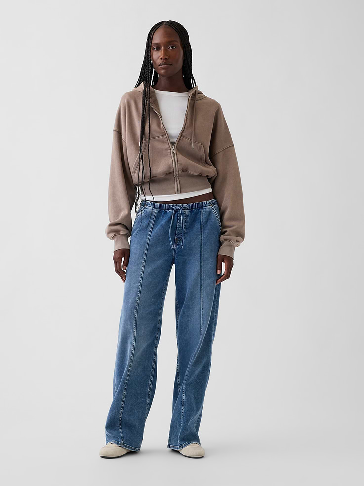 Image 1 of 7, Fit: A full-length knit denim loose jean that's fitted on the waist & relaxed all the way down., Fabric: 79% Cotton, 20% Recycled Materials, 1% Stretch., Stretch: Low Stretch Jeans. Authentic denim with a soft & easy lived-in feel.​, Rise: Low Rise Jeans., Look: An easy loose jean in a medium wash., Details: Elasticized waist with drawcords, front slant pockets, back patch pockets, & vertical seams at front., Responsibly Made: This pair of jeans is part of our water-saving Washwell program. Compared with conventional wash methods, Washwell uses at least 20% less water., More Sustainable Materials: Made with 15% polyester and 5% recycled cotton. Compared to virgin materials, using recycled materials helps to reduce resource use and waste., This product was made in a factory that invests in gender equity and women’s empowerment through RISE. Learn more at gapinc.com/equity ., Product #1185270
