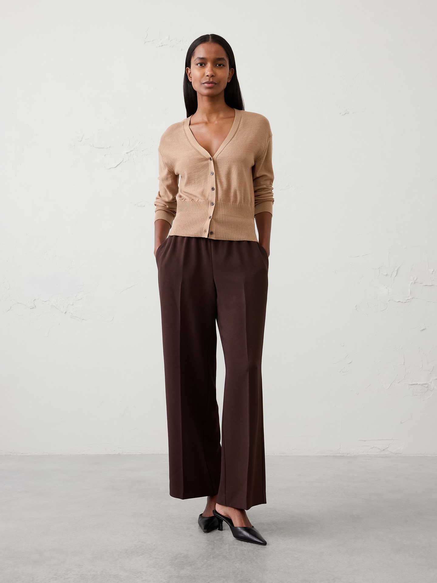 Image 1 of 4, Crafted from luxuriously soft Merino wool, this sweater offers lightweight warmth and natural breathability for all‑day comfort. Refined and versatile, it layers effortlessly while providing an elevated feel that transitions seamlessly through the seasons., V-neckline. Long sleeves., Drop shoulders., Button front closure., Ribbed neck and arm cuffs., Wide ripped hem., Straight hem., Made exclusively for Banana Republic Factory., Product #1176462