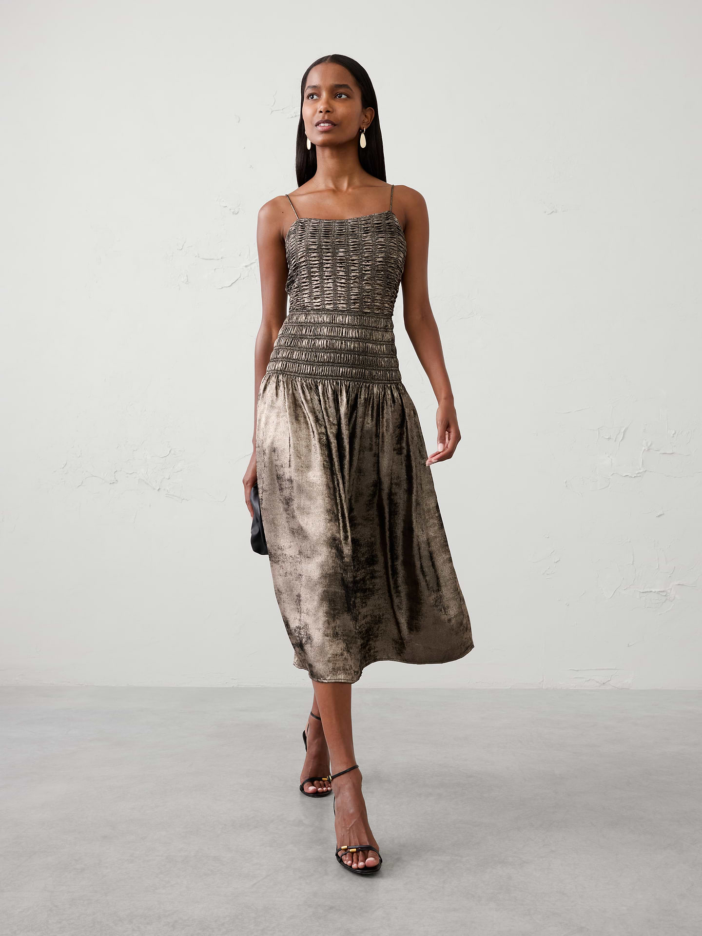 Image 1 of 4, Our customer‑favorite smocked silhouette gets a glamorous update in shimmering metallic lamé for an elevated take on occasion dressing., Adjustable spaghetti straps., Smocked bodice., Elasticated waist., Softly gathered skirt., Made exclusively for Banana Republic Factory., Product #1185684
