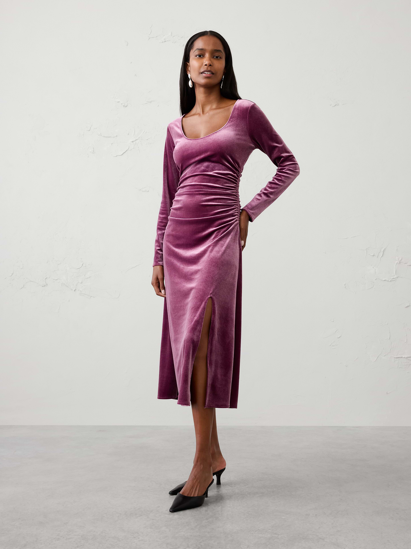 Image 1 of 4, Crafted from soft knit velvet with a subtle sheen, this sophisticated column silhouette is designed to flatter and move comfortably with you. Finished with a side slit for ease of movement and a touch of allure, this versatile dress is the perfect choice for holiday parties, dinners, and special occasions., Scoop neckline. Long sleeves., Side shirring at waist., Side slit detail., Made exclusively for Banana Republic Factory., Product #1185686