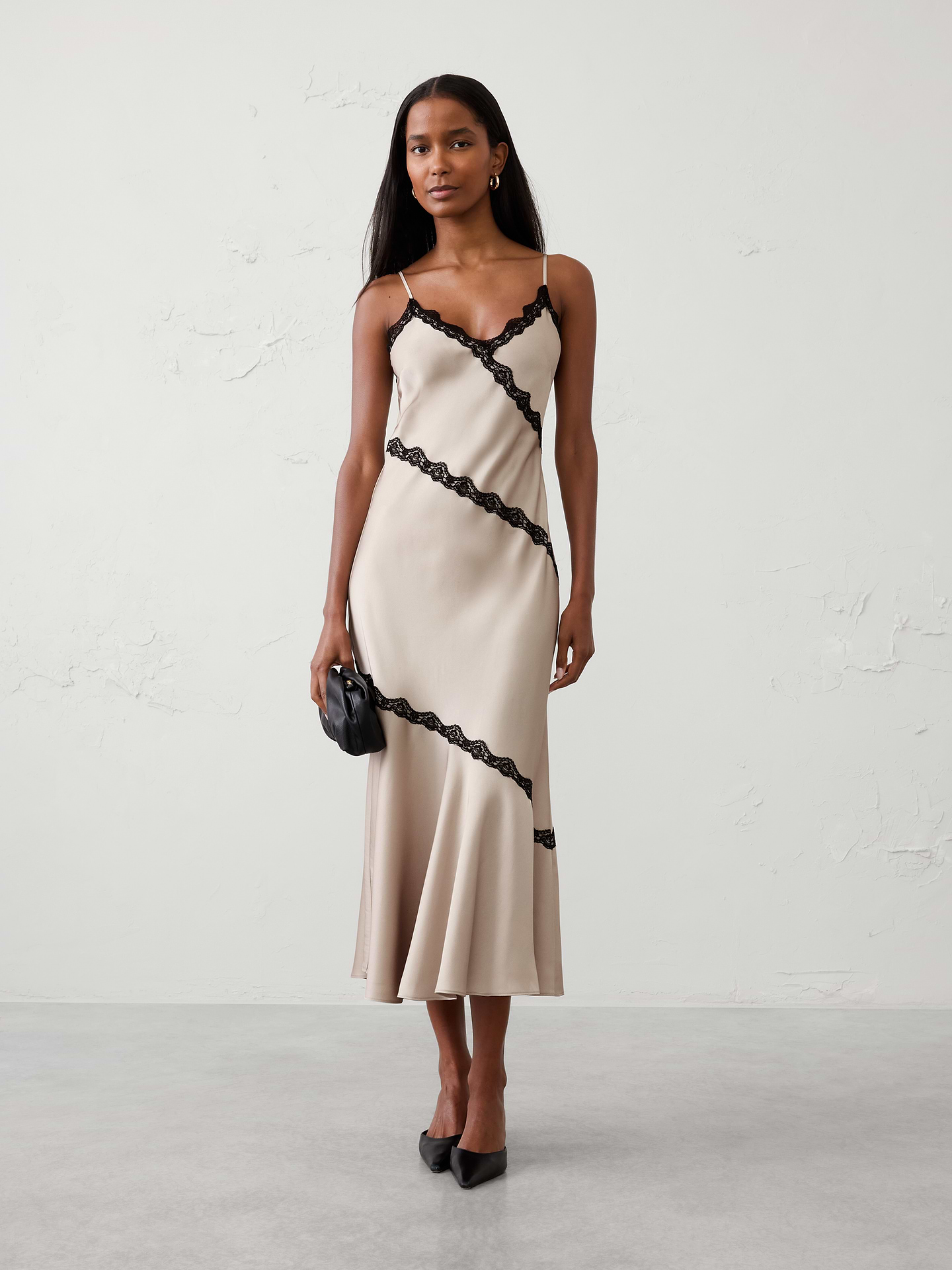 Image 1 of 8, Crafted from soft satin-back crepe, the bias-cut silhouette skims the figure for an effortlessly elegant look, while delicate lace trim traces the neckline and angled seam details for added femininity and dimension., V-neckline. Adjustable spaghetti straps., Delicate lace trim detailing throughout., Feminine slip-dress styling., Made exclusively for Banana Republic Factory., Product #1185690