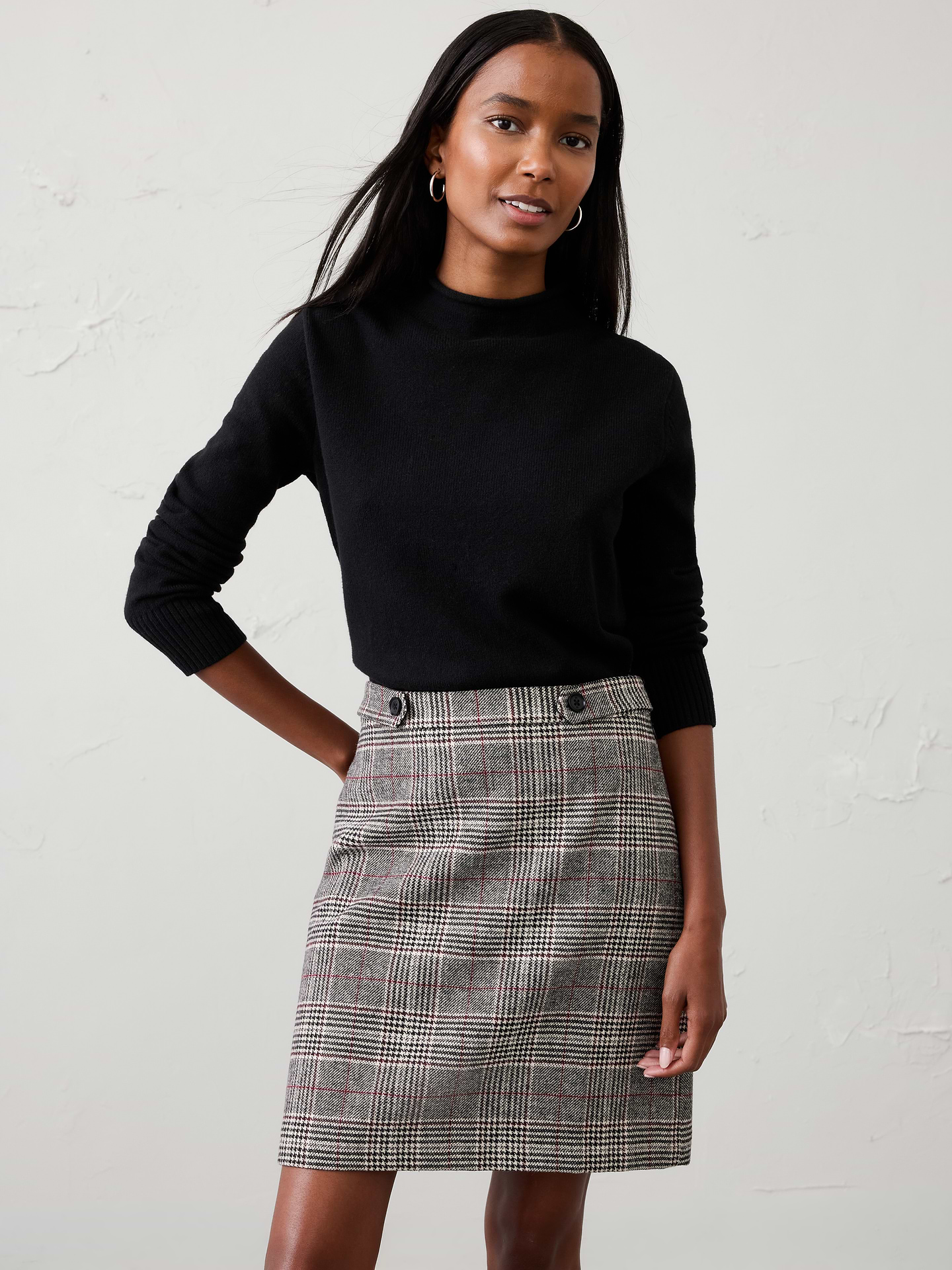 Image 1 of 3, A timeless plaid A‑line mini skirt, elevated with double button‑tab detailing for a modern tailored finish. Polished yet versatile, it blends classic heritage style with contemporary design, making it an easy choice for both workdays and weekend outings., Decorative button tabs at the front waist., Clean front panel., Invisible side zipper at wearer's left., Back waist darts., Made exclusively for Banana Republic Factory., Product #1185773
