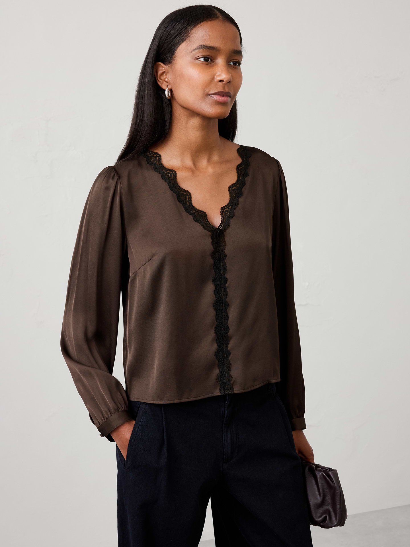Image 1 of 5, Romantic lace details bring an elevated feel to this feminine blouse, making it a perfect choice for holiday celebrations and special occasions. Delicate trim and soft draping create an effortlessly polished look that transitions beautifully from dinner parties to evening events., V‑neckline. Long blouson sleeves with buttoned cuffs., Scalloped lace trim frames the neckline extending down the front., Made exclusively for Banana Republic Factory., Product #1185900