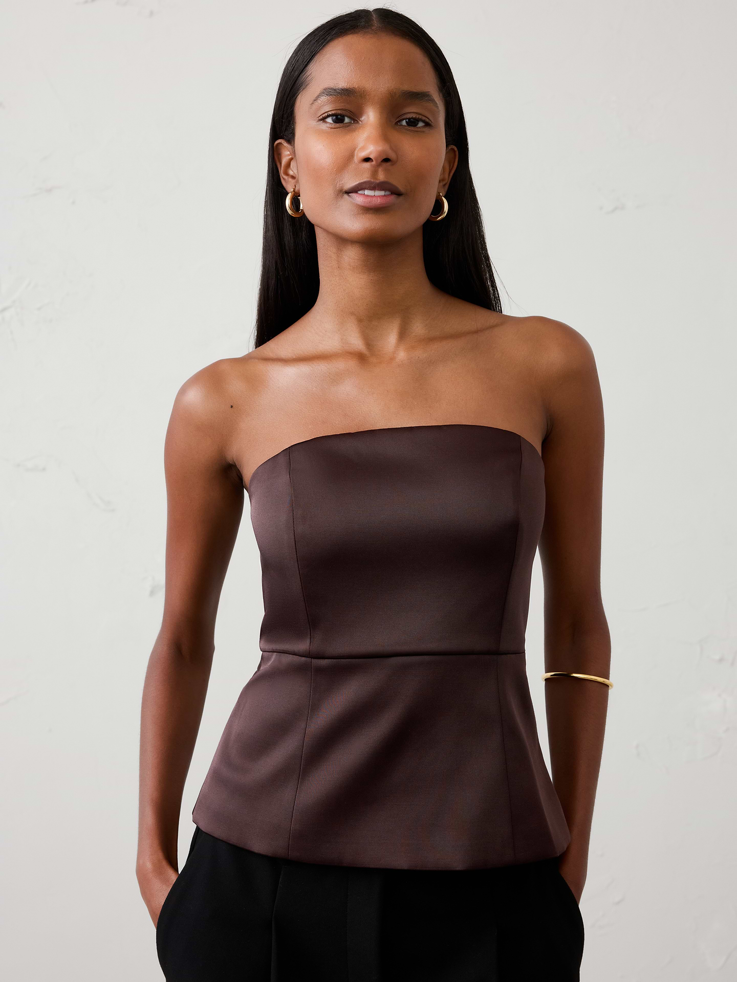 Image 1 of 4, A customer‑favorite silhouette returns. Designed with a sleek, structured fit and lustrous satin finish, this bustier brings a modern, elevated touch to occasion dressing., SUSTAINABILITY: Made with 81% recycled polyester., Straight neckline. Sleeveless., Grip tape along neckline., Invisible side zipper at wearer's left., Seamed waist., Back vented hem opens from the waist., Fully lined., Made exclusively for Banana Republic Factory., Product #1185886