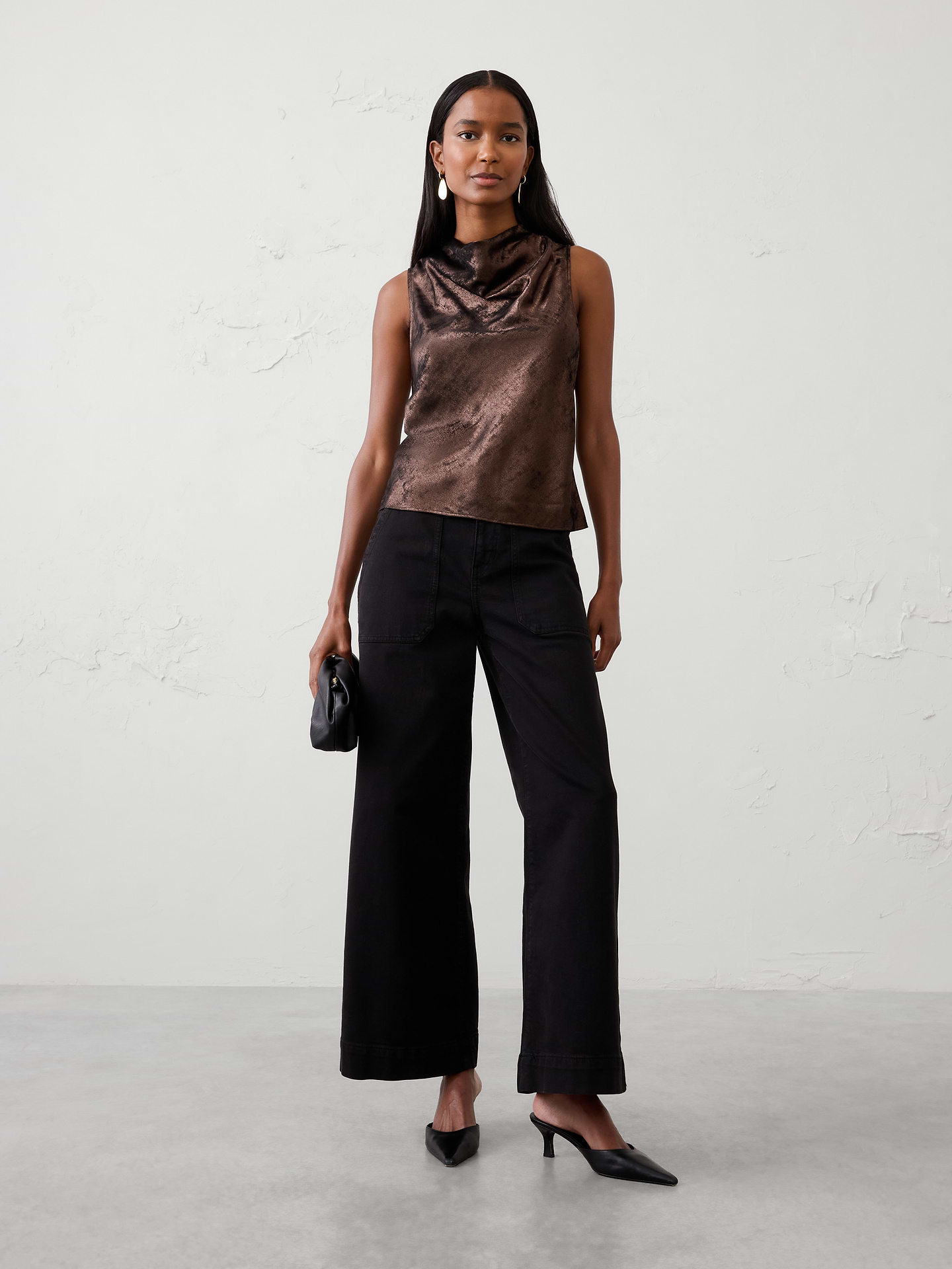 Image 1 of 4, Crafted in our refined metallic lamé fabrication, this elevated top features a graceful cowl neckline for an effortlessly sophisticated look. The subtle shimmer makes it a standout choice for holiday gatherings, evenings out, and special occasions., Soft cowl high neckline. Sleeveless., Back keyhole opening with two-button closure., Lamé fabric gives a special eye-catching sheen, making it ideal for holiday events., Made exclusively for Banana Republic Factory., Product #1185910