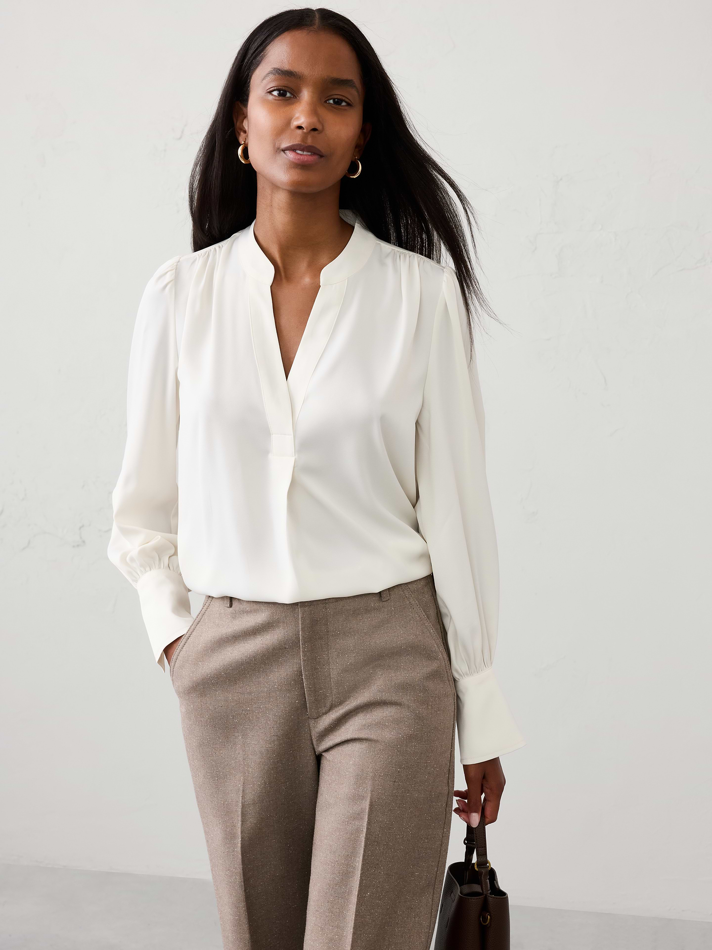 Image 1 of 4, A customer favorite returns. Statement sleeves add soft volume and dimension, while the easy silhouette delivers versatile styling for both work and weekend wear., SUSTAINABILITY: Made with 55% recycled polyester., Band collar with split neckline. Long sleeves with extended cuffs and button closures., All over shirring detailing., Back yoke., Made exclusively for Banana Republic Factory., Product #1185909