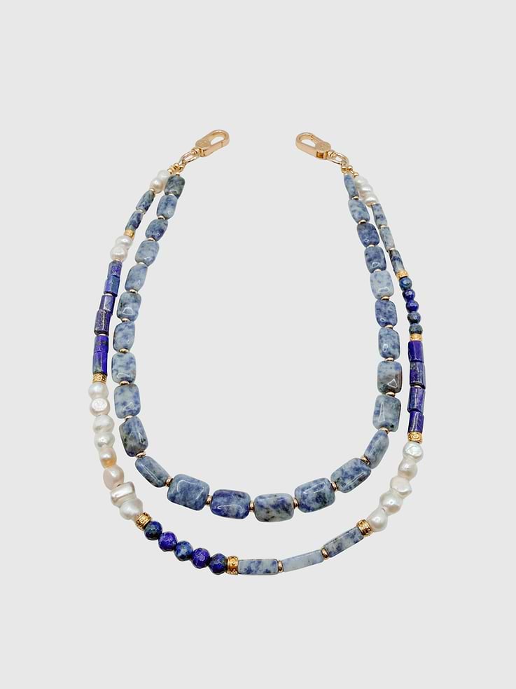 Image 1 of 1, Refined, layered, and effortlessly elevated, the Harbor Double Strap is handcrafted with a beautiful mix of sodalite stones, freshwater pearls, and lapis accents finished with subtle gold spacer details., Universal Phone Hitch required to attach to your phone case, sold separately., Over time, certain bead colors may lose their vibrancy due to exposure to air, water, and heat., Due to natural variations in gemstones and beads, product may differ slightly from displayed photos., THE CÆP in no way guarantees the integrity of your smartphone when using this strap.
