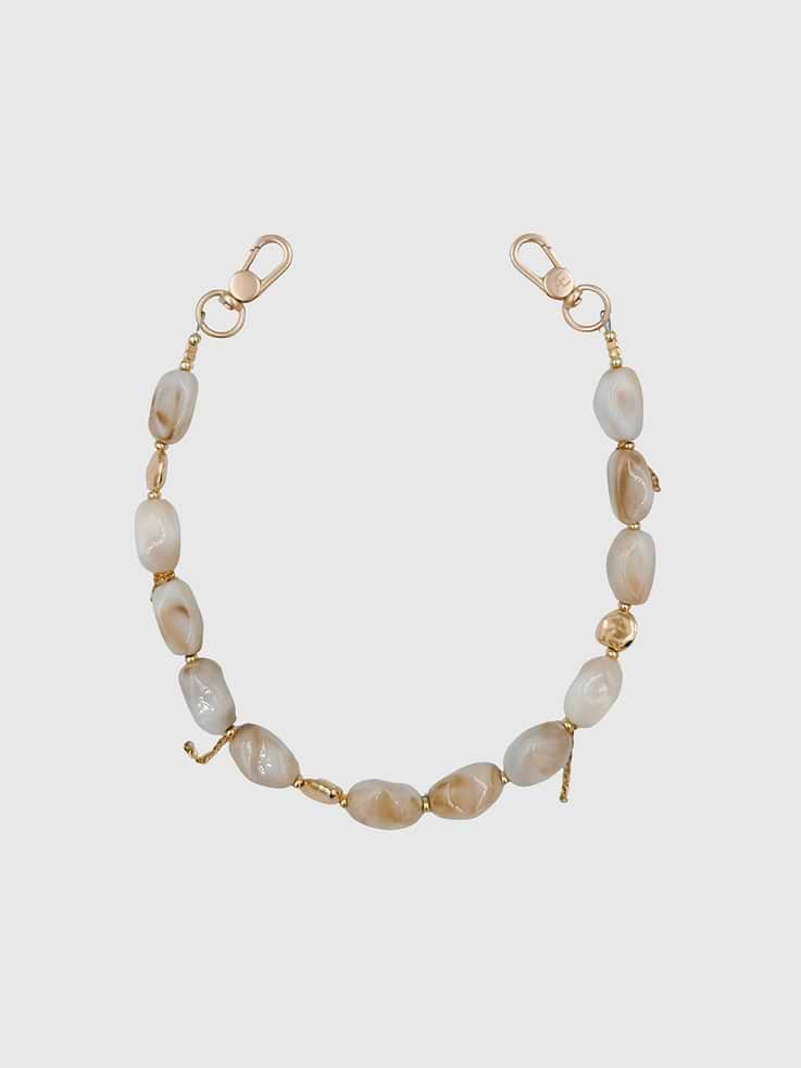 Image 1 of 1, Bold, sculptural, and effortlessly modern, the Lune Strap is handcrafted with irregular square resin stone beads and gold plated spacer accents, creating a striking contemporary look with natural movement and shine., Universal Phone Hitch required to attach to your phone case, sold separately., Over time, certain bead colors may lose their vibrancy due to exposure to air, water, and heat., Due to natural variations in gemstones and beads, product may differ slightly from displayed photos., THE CÆP in no way guarantees the integrity of your smartphone when using this strap.