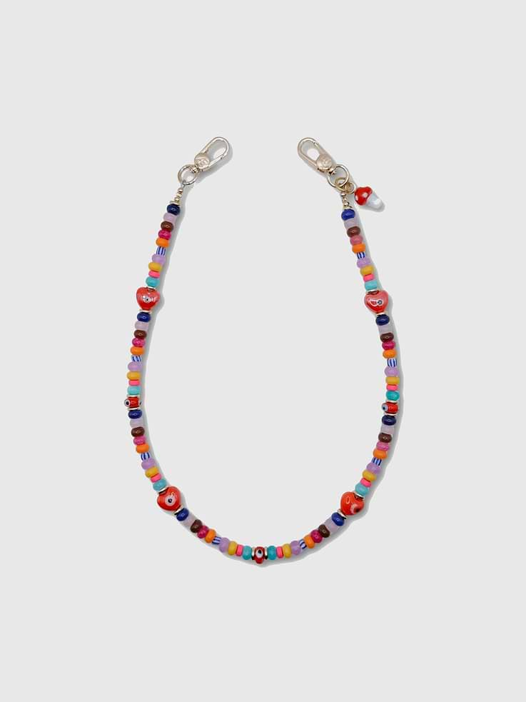 Image 1 of 1, Colorful, playful, and full of personality, the Etta Strap is handcrafted with a vibrant mix of multicolor glass beads, evil eye accents, and hand-painted heart beads finished with a whimsical mini mushroom charm., Universal Phone Hitch required to attach to your phone case, sold separately., Over time, certain bead colors may lose their vibrancy due to exposure to air, water, and heat., Due to natural variations in gemstones and beads, product may differ slightly from displayed photos., The CAEP in no way guarantees the integrity of your smartphone when using this strap.