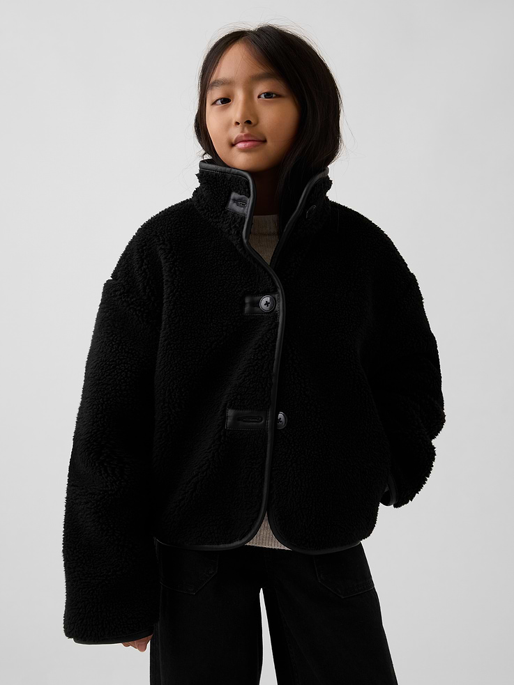 Image 1 of 5, Soft sherpa jacket with vegan leather trim. In a relaxed fit and cropped length., Mockneck., Long sleeves with drop shoulders., Button front., Vegan leather trim at button hole patches and binding., Made with 30% recycled polyester. Compared to virgin materials, using recycled materials helps reduce resource use and waste., Product #1179995