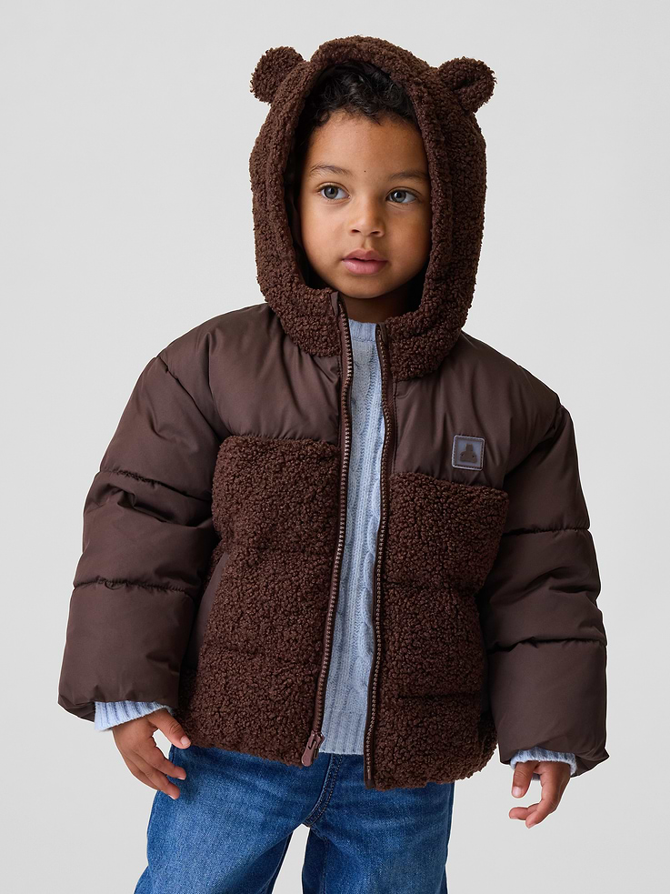 Image 1 of 4, Cozy sherpa and water-resistant shell puffer jacket., Sherpa hood with bear ear appliques at top., Long puffer sleeves with a puffer yoke., Zipper front., Brannan Bear emblem at chest., Sherpa at front and back body., Elasticized cuffs and hem., Made with 100% recycled polyester. Compared to virgin materials, using recycled materials helps reduce resource use and waste., This product was made in a factory that invests in gender equity and women’s empowerment through RISE. Learn more at gapinc.com/equity ., Product #1184953