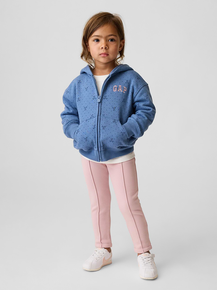 Image 1 of 4, Soft, stretch knit leggings with a cozy sherpa lining., Elasticized waist., Pintuck detailing at front., Made with 37% recycled polyester. Compared to virgin materials, using recycled materials helps reduce resource use and waste., This product was made in a factory that invests in gender equity and women’s empowerment through RISE. Learn more at gapinc.com/equity ., Product #1184974