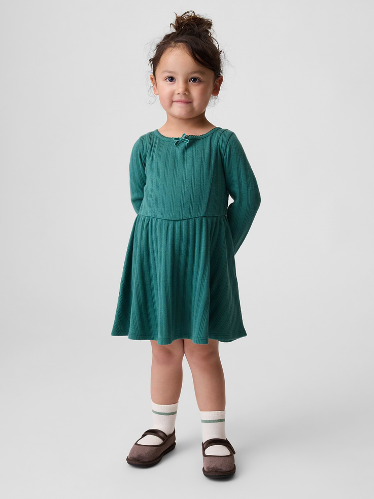 Image 1 of 3, Soft, pointelle rib knit dress., Round neck with ribbon bow at front., Loop button keyhole closure at back., Long sleeves., Bodice and waist seams., Product #1183537