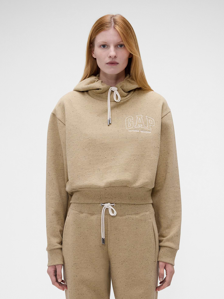 Image 1 of 7, Textured, heavyweight nepped fleece hoodie. In an oversized, cropped fit., Hooded neckline with drawcords., Long sleeves., Embroidered Gap x Victoria Beckham arch logo at chest., Banded hem and cuffs., Made with 14% recycled polyester. Compared to virgin materials, using recycled materials helps reduce resource use and waste., Product #1183578