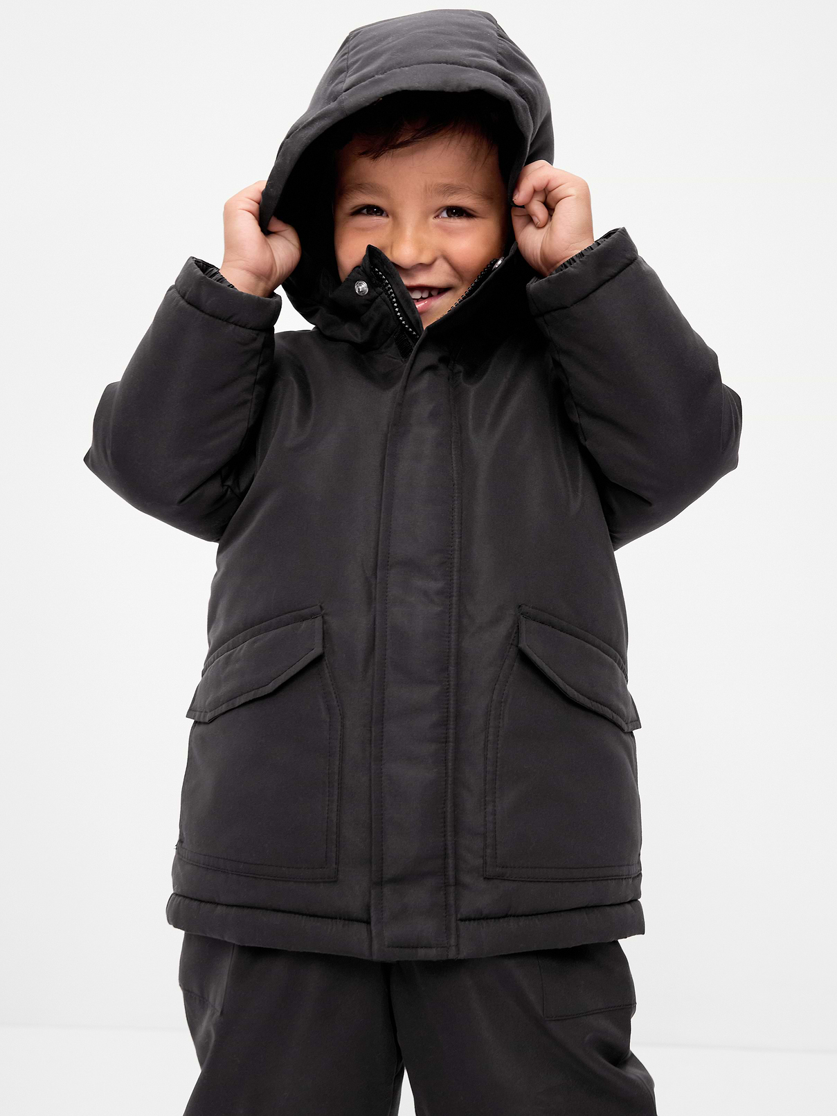 Image 1 of 3, built-in hood, standing collar, long sleeves, elasticized cuffs, hidden full-length zipper, full length adhesive secure close tabs, adhesive secure close flap pockets at hem, Product #908560