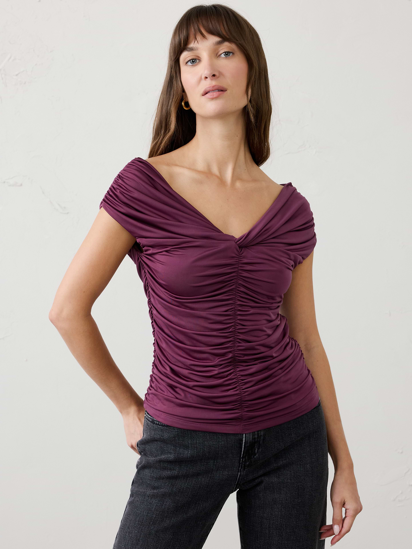 Image 1 of 3, Crafted from a sleek jersey fabric with a silk‑like hand feel and matte finish, this top offers exceptional stretch and beautiful drape. Front ruching creates a flattering silhouette, while the comfortable fabric makes it an easy, elevated option for dressier occasions., Off‑the‑shoulder sweetheart neckline. Cap sleeves., Fitted at the waist., Center front and back ruching., Side seam gathering., Made exclusively for Banana Republic Factory., Product #1185987