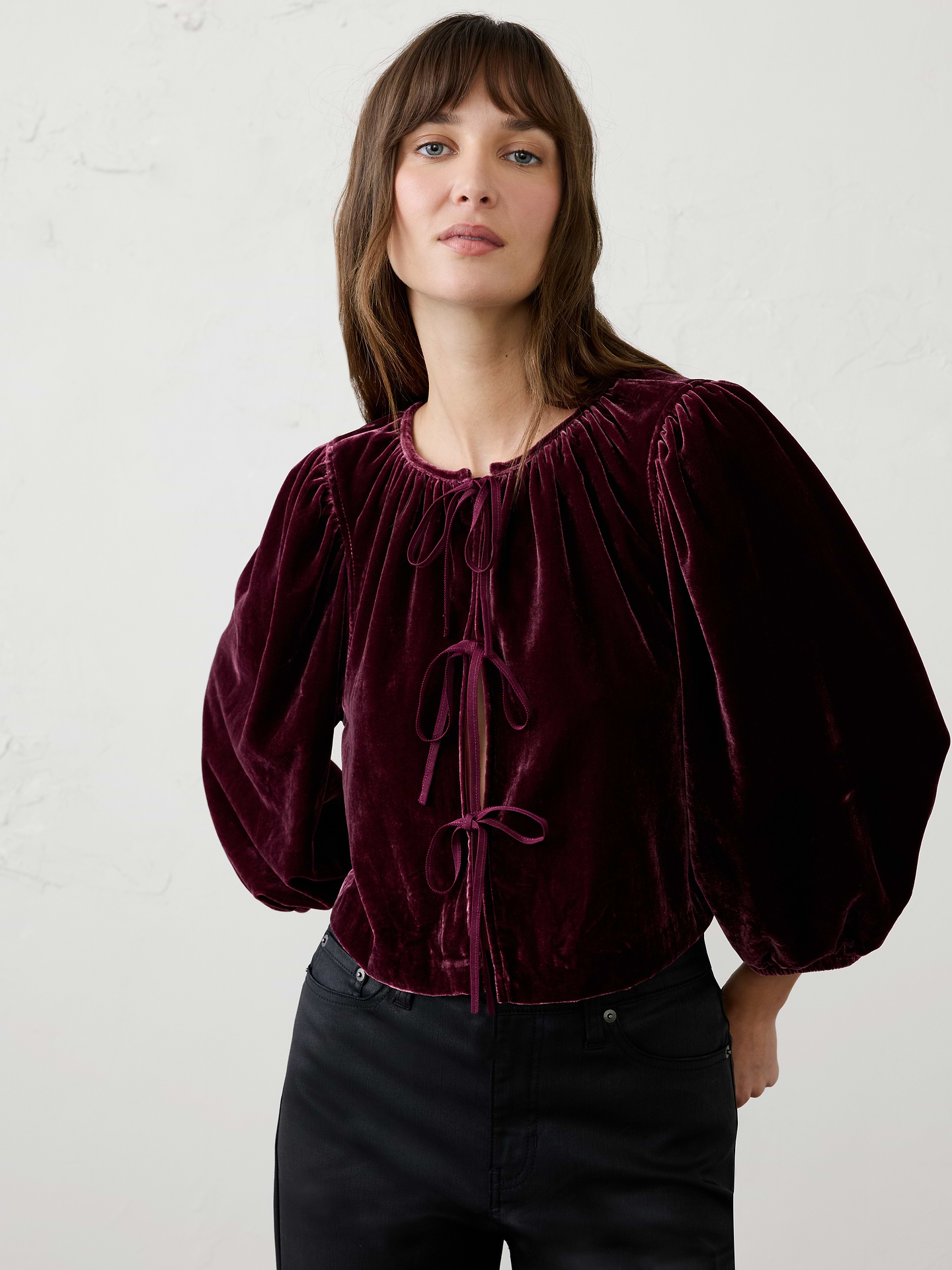 Image 1 of 4, Made from luxuriously soft velvet, this top features an open tie‑front detail that creates an effortlessly feminine silhouette. The top can be worn on its own or layered over a dress for added texture and versatility., Round neckline with soft gathered detailing., Three-quarter length sleeves with elasticated cuffs., Tie-front closure., Soft gathering continues across the back neckline, Made exclusively for Banana Republic Factory., Product #1185911