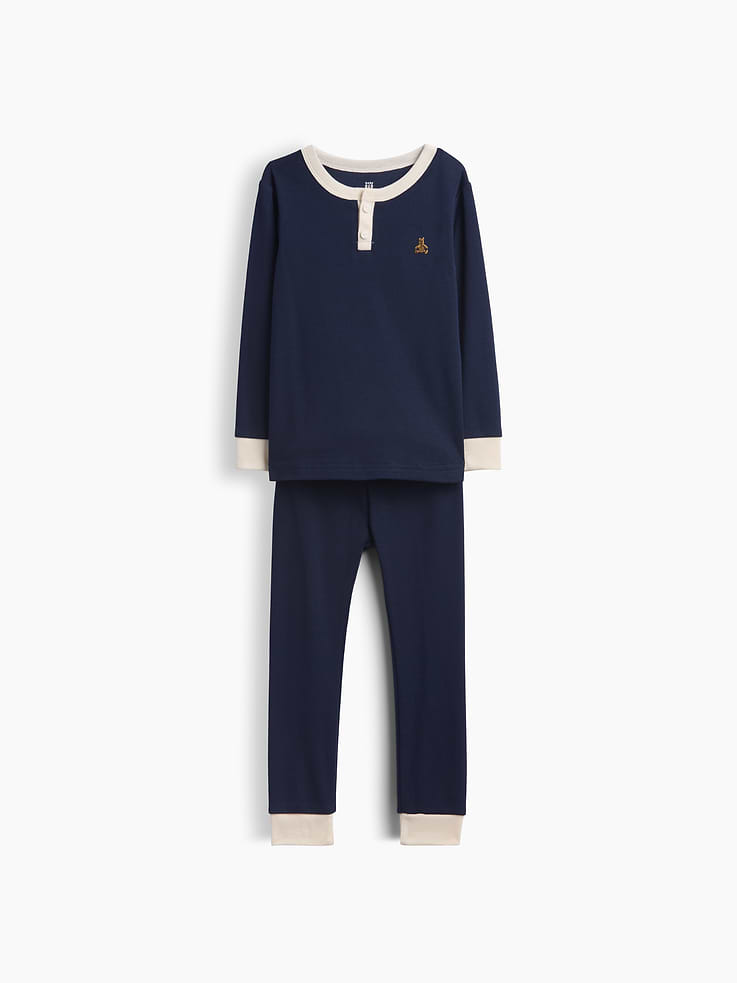 Image 1 of 2, Our comfiest PJs—now softer than ever. Cozy brushed cotton on the inside. All their favorite prints & colors on the outside., Soft cotton Henley pajama top and pants PJ set with a cozy brushed interior., Crewneck with front button placket., Long sleeves., Elasticized waist at PJ pants., Banded cuffs., Colorblock design., Made with 100% organically grown cotton which is grown without the use of synthetic pesticides and fertilizers., This product was made in a factory that invests in gender equity and women’s empowerment through RISE. Learn more at gapinc.com/equity ., Product #913293