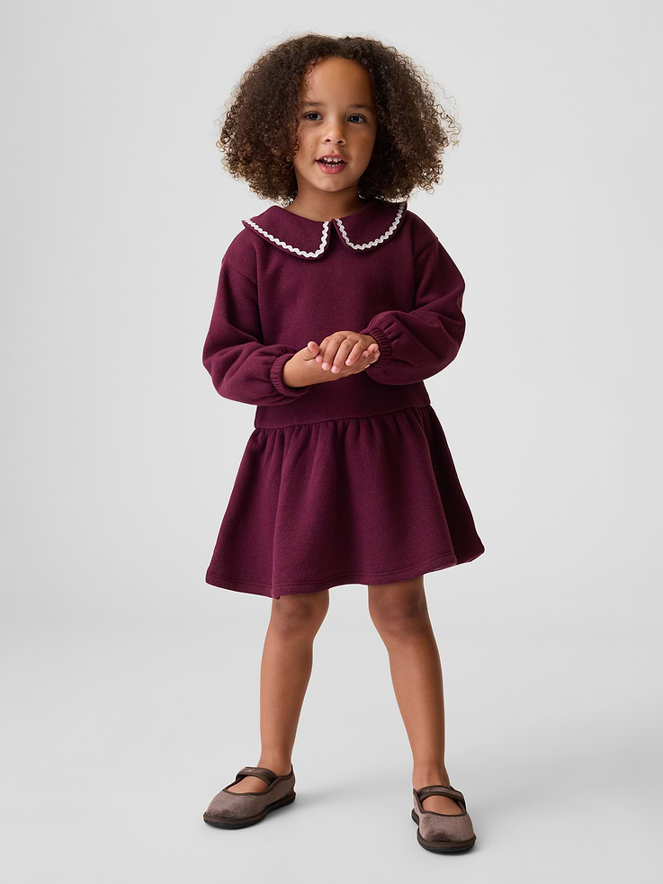 Image 1 of 3, Soft cotton-blend fleece sweatshirt dress., Peter Pan collar with ric rac trim and loop button keyhole closure., Long sleeves with elasticized cuffs., Shirring at drop waist., Made with 21% recycled polyester. Compared to virgin materials, using recycled materials helps reduce resource use and waste., Product #912137