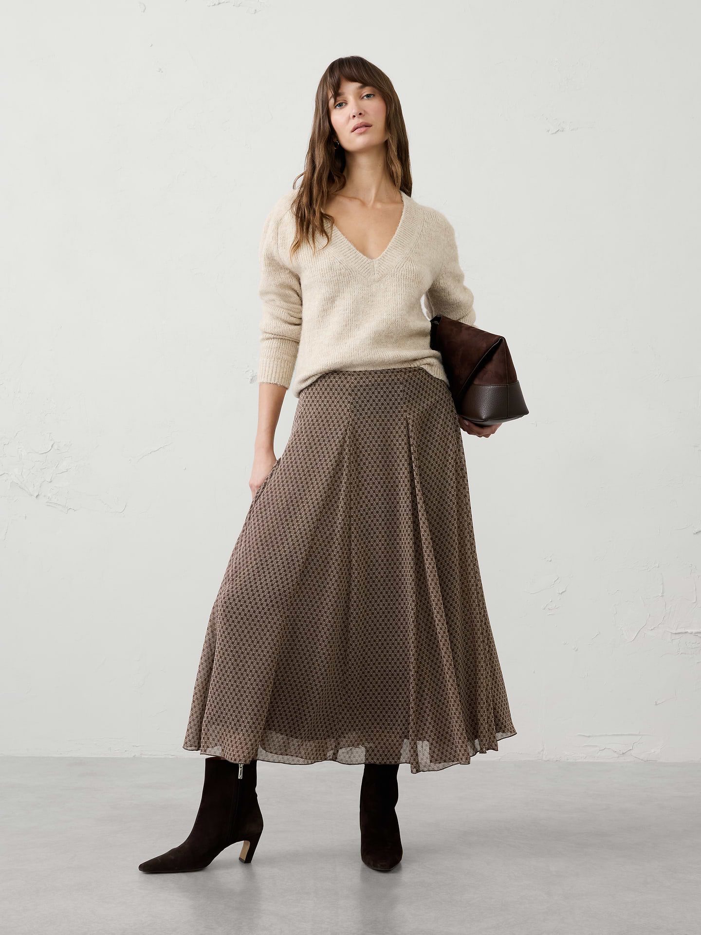Image 1 of 4, Float through your day in effortless style with this swing pleated midi skirt. Designed with a graceful A-line silhouette, this elegant skirt features soft pleats that create beautiful movement and flow with every step. The midi length offers timeless versatility, while the lightweight fabric drapes beautifully for a flattering, feminine look. Perfect for dressing up with heels or styling casually with flats and knitwear, this skirt transitions seamlessly from workdays to special occasions., Smooth waistband for a clean, polished finish., Soft pleating adds dimension and graceful drape., Side zip closure., Elegant swing silhouette with fluid movement., Fully lined., Made exclusively for Banana Republic Factory., Product #1185764