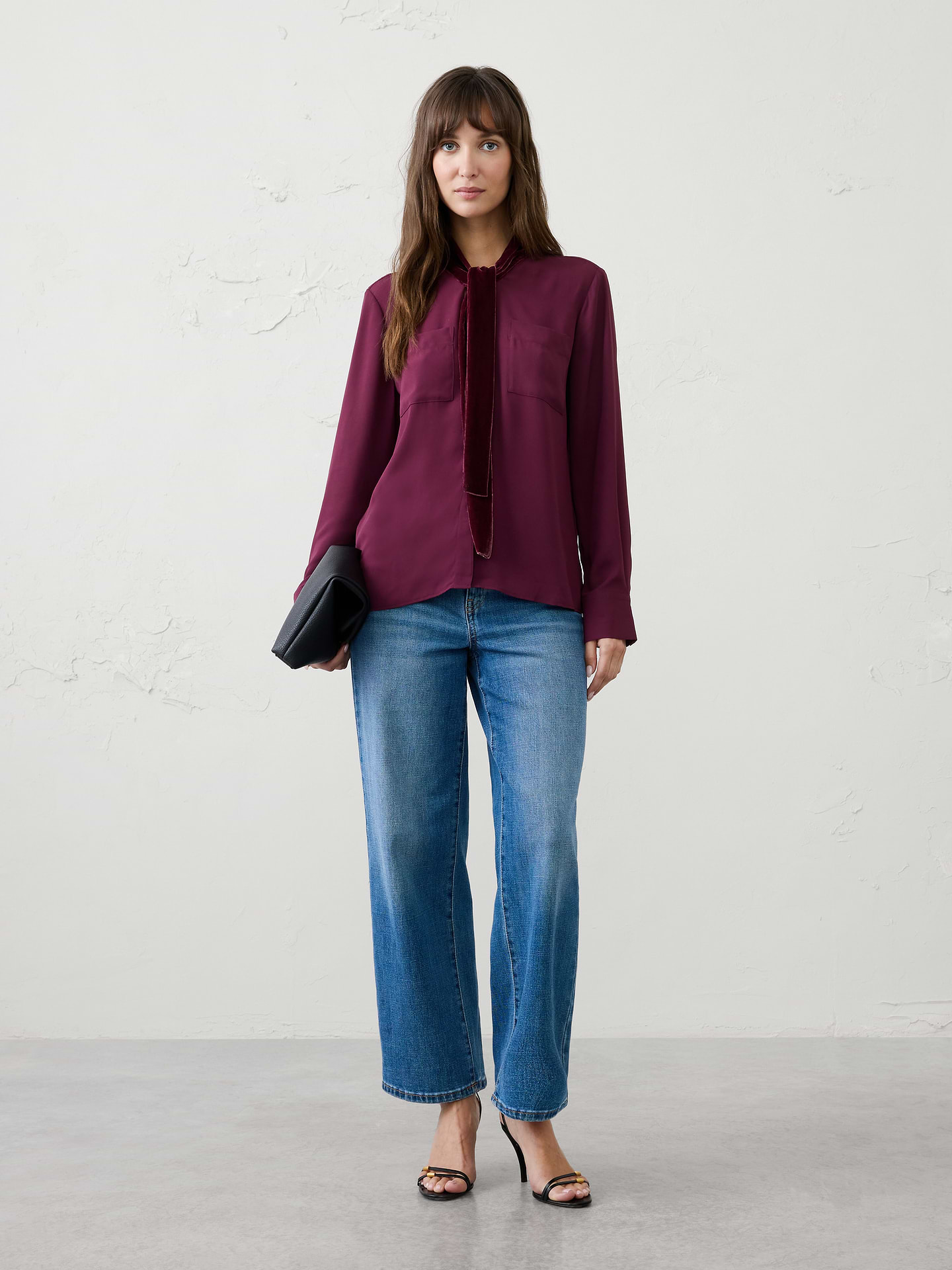 Image 1 of 4, Elevate your holiday wardrobe with this sophisticated blouse, designed with an elegant velvet scarf detail that drapes effortlessly at the neckline. The relaxed silhouette and fluid woven body create an easy, polished look, while tailored cuffs and utility-inspired chest pockets add a modern touch. Refined yet versatile, it's the perfect piece for festive gatherings, special occasions, and elevated everyday dressing., V-neckline with attached velvet scarf. Long sleeves with wide buttoned cuffs., Button‑front closure., Dual chest patch pockets., Back yoke with center box pleat., Made exclusively for Banana Republic Factory., Product #1185903