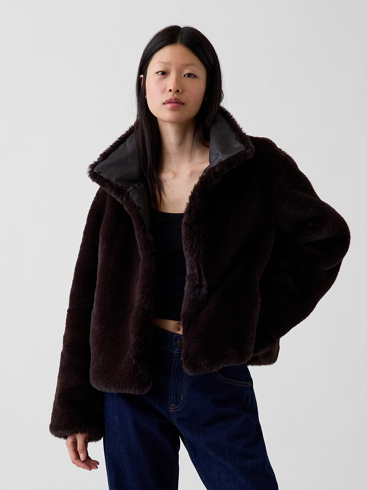 Image 1 of 6, Cozy faux fur jacket with vegan leather detailing. In a cropped length., High collar., Long sleeves., Hook-and-eye closures at front placket., Side pockets., Fully lined., Made with 100% recycled polyester. Compared to virgin materials, using recycled materials helps reduce resource use and waste., This product was made in a factory that invests in gender equity and women’s empowerment through RISE. Learn more at gapinc.com/equity ., Product #1184880