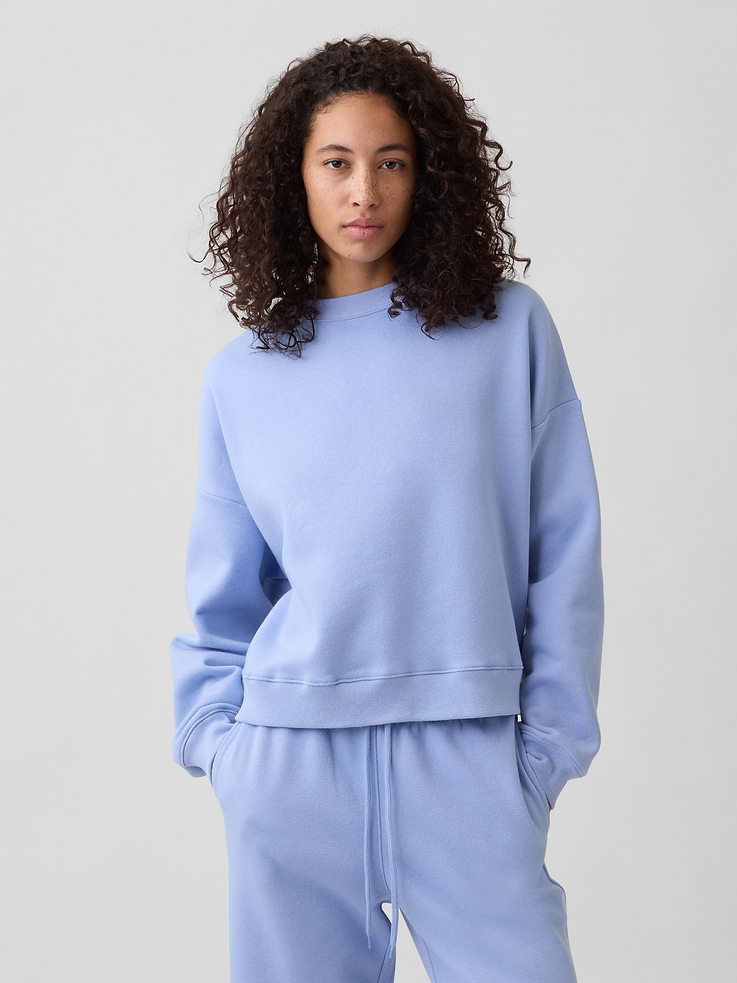 Image 1 of 5, This style is made with 23% recycled polyester. Compared to virgin materials, using recycled materials helps to reduce resource use and waste., Soft, comfy fleece., Dropped shoulder, long sleeves with banded cuffs., Crewneck., Banded wedge hem., Note: The dye used in the crafting of this product is prone to crocking, or color transfer. Please avoid contact with light-colored fabric or upholstery., This product was made in a factory that invests in gender equity and women’s empowerment through RISE. Learn more at, Product #734331