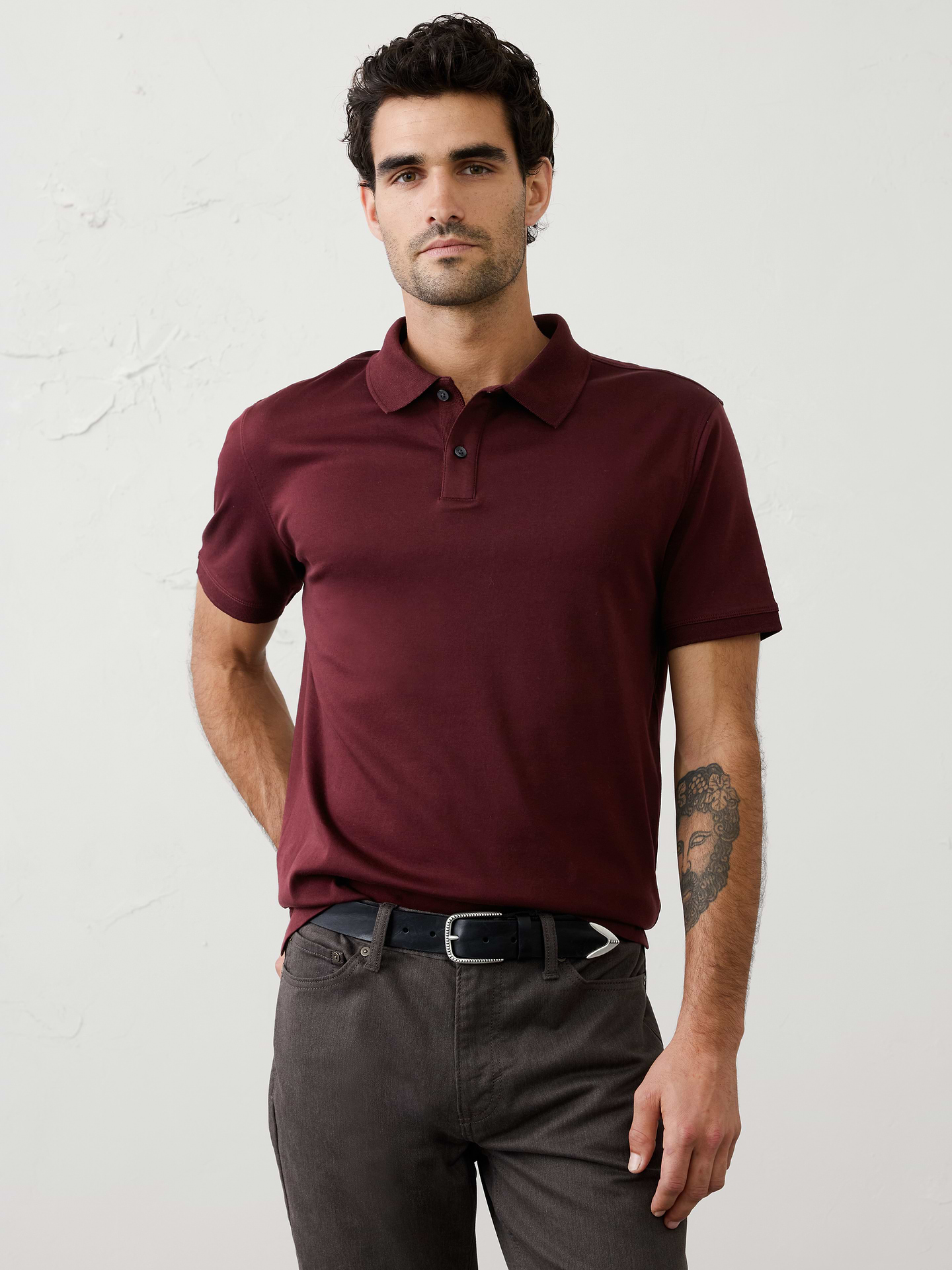 Image 1 of 8, Made with 100% cotton interlock, which is extremely soft, firm, and absorbent. Mercerization treatment gives this fabric a silk-like lustrous appearance for a polished look and hand feel, adding strength and reducing shrinkage., Polo collar with button placket. Short sleeves., Straight hem with side vents., Made exclusively for Banana Republic Factory., Product #667172