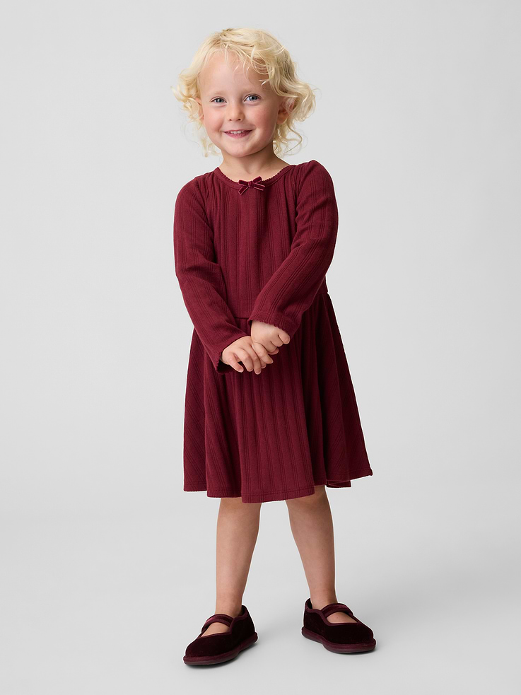 Image 1 of 3, Soft, pointelle rib knit dress., Round neck with ribbon bow at front., Loop button keyhole closure at back., Long sleeves., Bodice and waist seams., Product #1183537