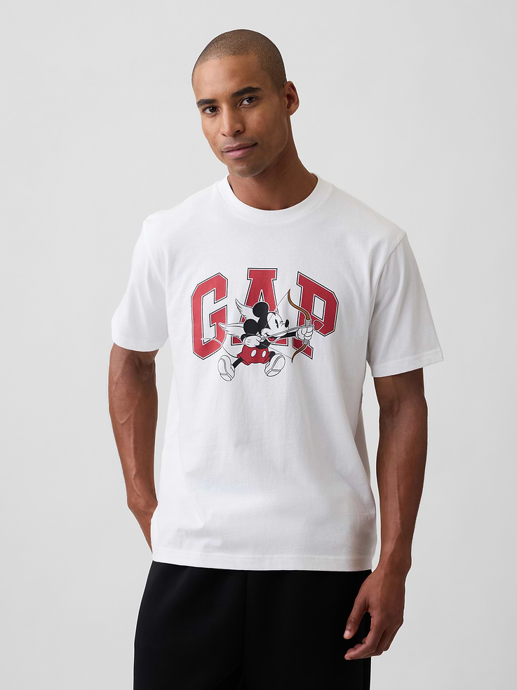 Image 1 of 5, A very special collaboration between Gap and Disney— two timeless, iconic American brands— led us to create a collection that celebrates Mickey Mouse and Minnie Mouse., Soft jersey knit., Dropped shoulder, short sleeves., Crewneck., Gap logo with Mickey Mouse Valentine's Day graphic at front., This product was made in a factory that invests in gender equity and women’s empowerment through RISE. Learn more at, Product #1186904