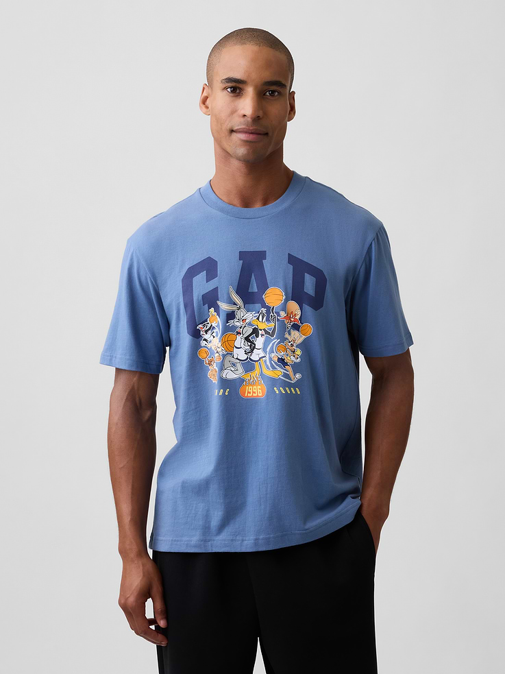 Image 1 of 5, Soft jersey knit., Dropped shoulder, short sleeves., Crewneck., Gap logo with Space Jam graphic at front., This product was made in a factory that invests in gender equity and women’s empowerment through RISE. Learn more at, Product #1186952