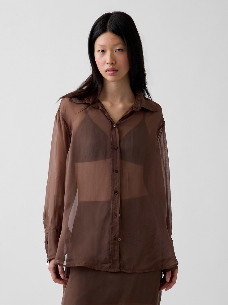 Image 1 of 5, Our oversized shirt pulled straight from the archives. Always easy. Forever iconic., Sheer organza oversized shirt., Point collar, button front., Long sleeves with button cuffs., This product was made in a factory that invests in gender equity and women’s empowerment through RISE. Learn more at gapinc.com/equity ., Product #1184603