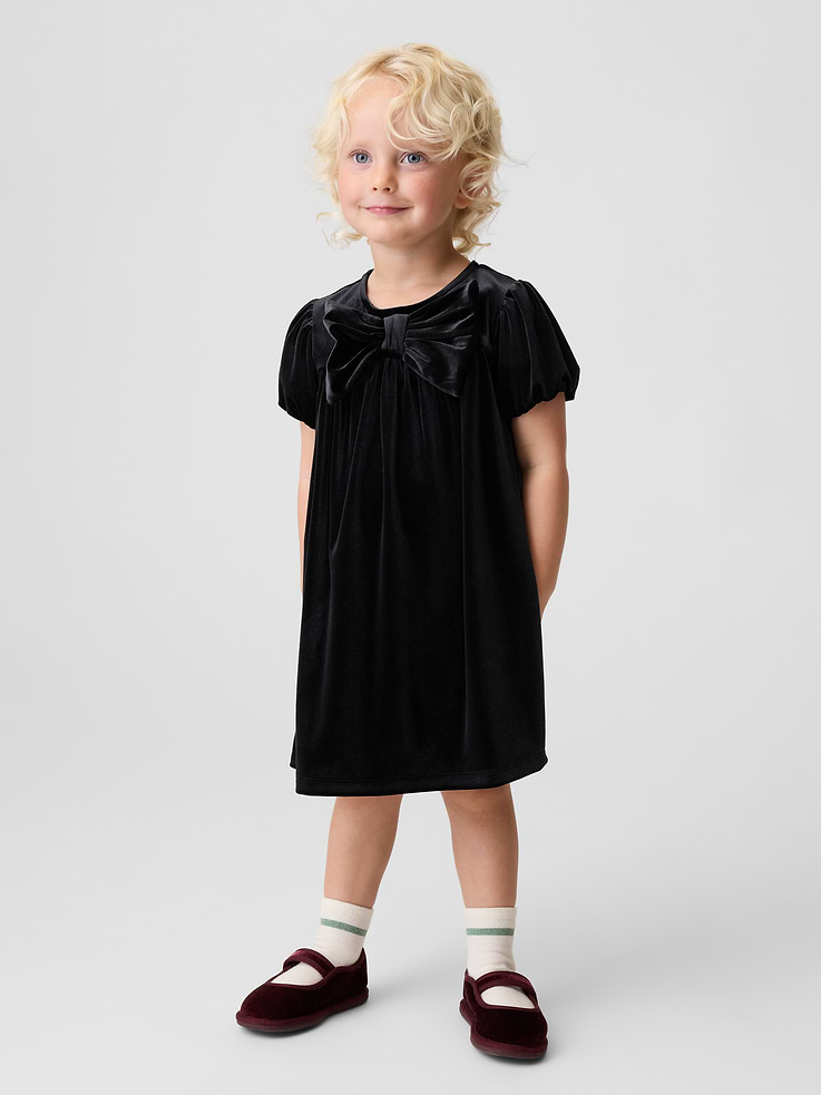 Image 1 of 4, Soft, stretch velour knit dress., Round neck with back button placket., Lawn-lined puff sleeves with elasticized openings., Bow detail at front., This product was made in a factory that invests in gender equity and women’s empowerment through RISE. Learn more at gapinc.com/equity ., Product #1185566