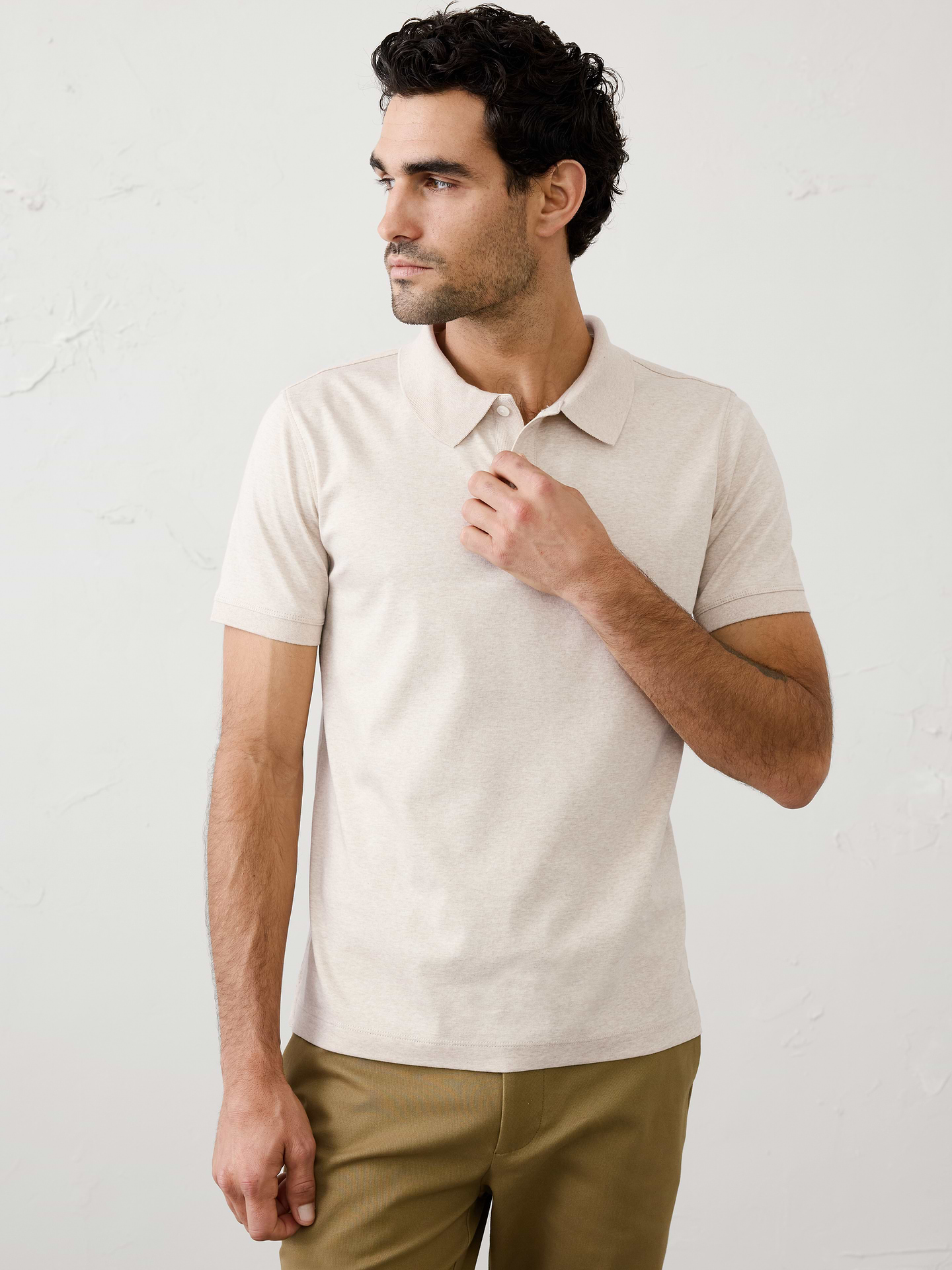 Image 1 of 8, Made with 100% cotton interlock, which is extremely soft, firm, and absorbent. Mercerization treatment gives this fabric a silk-like lustrous appearance for a polished look and hand feel, adding strength and reducing shrinkage., Polo collar with button placket. Short sleeves., Straight hem with side vents., Made exclusively for Banana Republic Factory., Product #667136