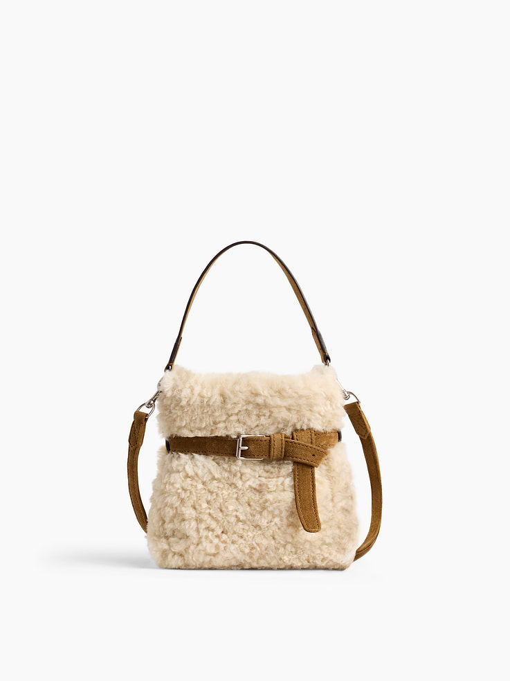 Image 1 of 6, Soft sherpa shoulder bag., Worn handheld, elbow, crossbody, or over the shoulder., Vegan suede handle and removable shoulder strap., Magnetic closure., Belted detailing., Product #1189089